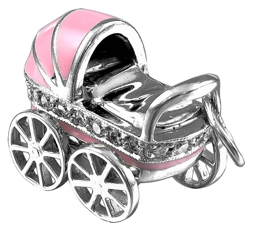 A perfect present for a lucky baby girl:  a figural "baby carriage" in platinum.  Made and signed by TIFFANY & CO.  Decorated with pink enamel and a band of brilliant cut diamonds.  1" x 1/2."  For the baby and mother who