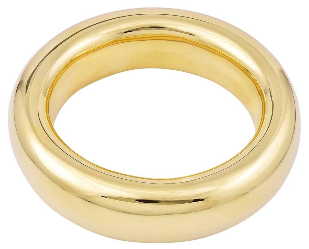 Sculptural simplicity.  Big and beautiful "donut" oval bangle bracelet.  Made by Elsa Peretti c.1981for TIFFANY & CO.  Heavy gauge 18K yellow gold.  Effortlessly chic.  Feels and looks like liquid gold.  For a medium to large