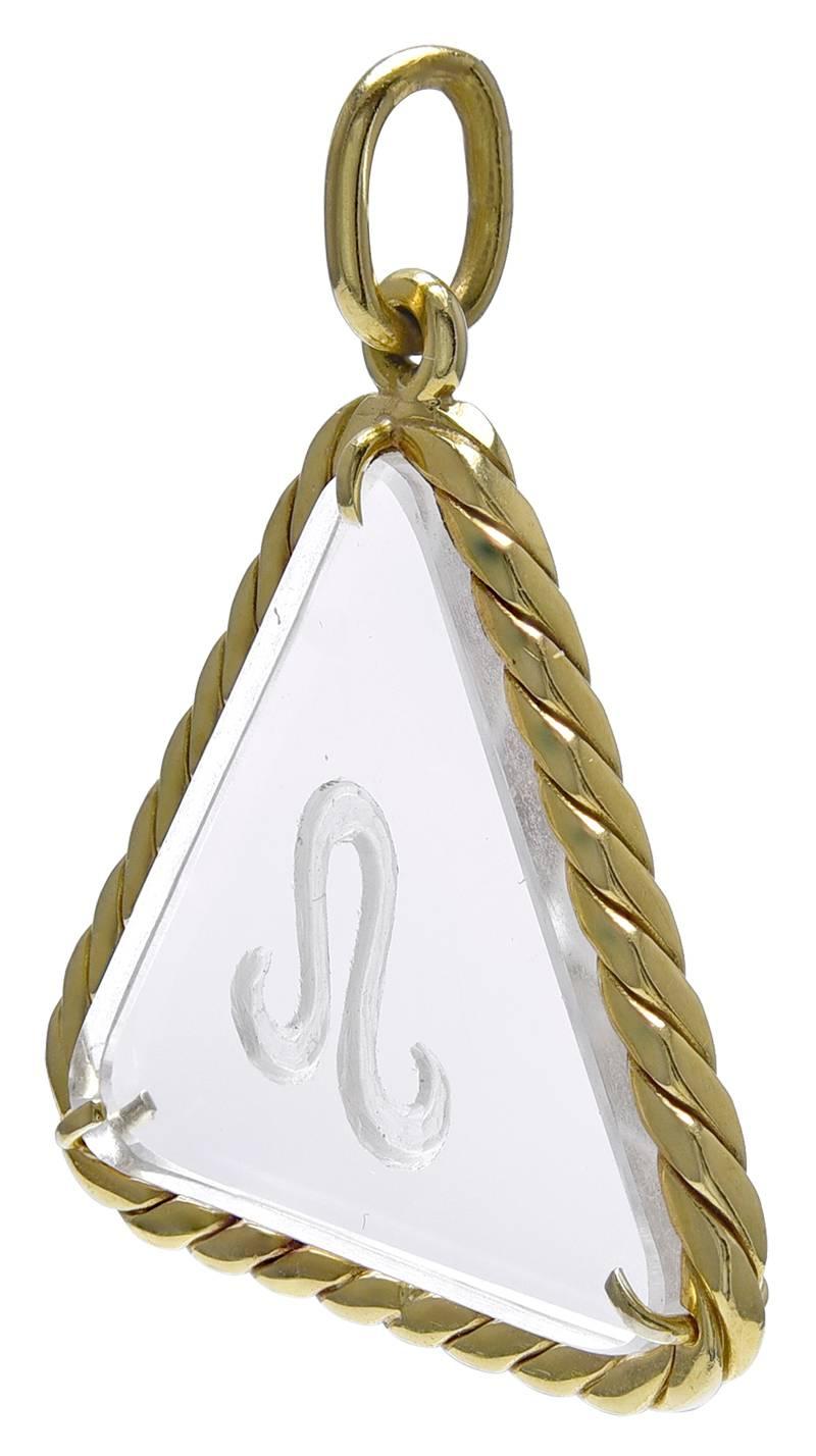 Wonderful pendant/charm.  18K yellow gold and rock crystal.  Braided gold border; "Leo" engraved on the crystal.  1 1/8" x 1 1/8." A unique rendering.

Alice Kwartler has sold the finest antique gold and diamond jewelry and