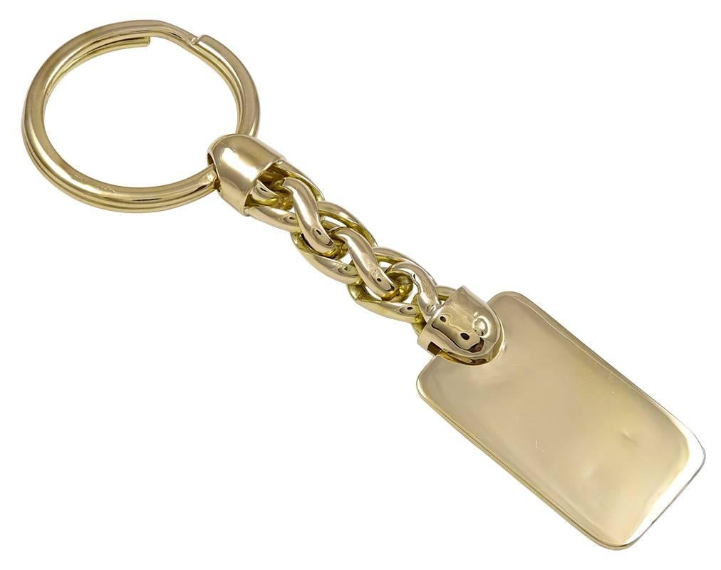 "FERRARI" key ring.  18K yellow gold, with yellow, red, white and black enamel.  Deeply beveled disc with the Ferrari symbol, attached to a braided link and a loop.  Heavy gauge gold.  3 1/2" long x 2/3."  

Alice Kwartler has