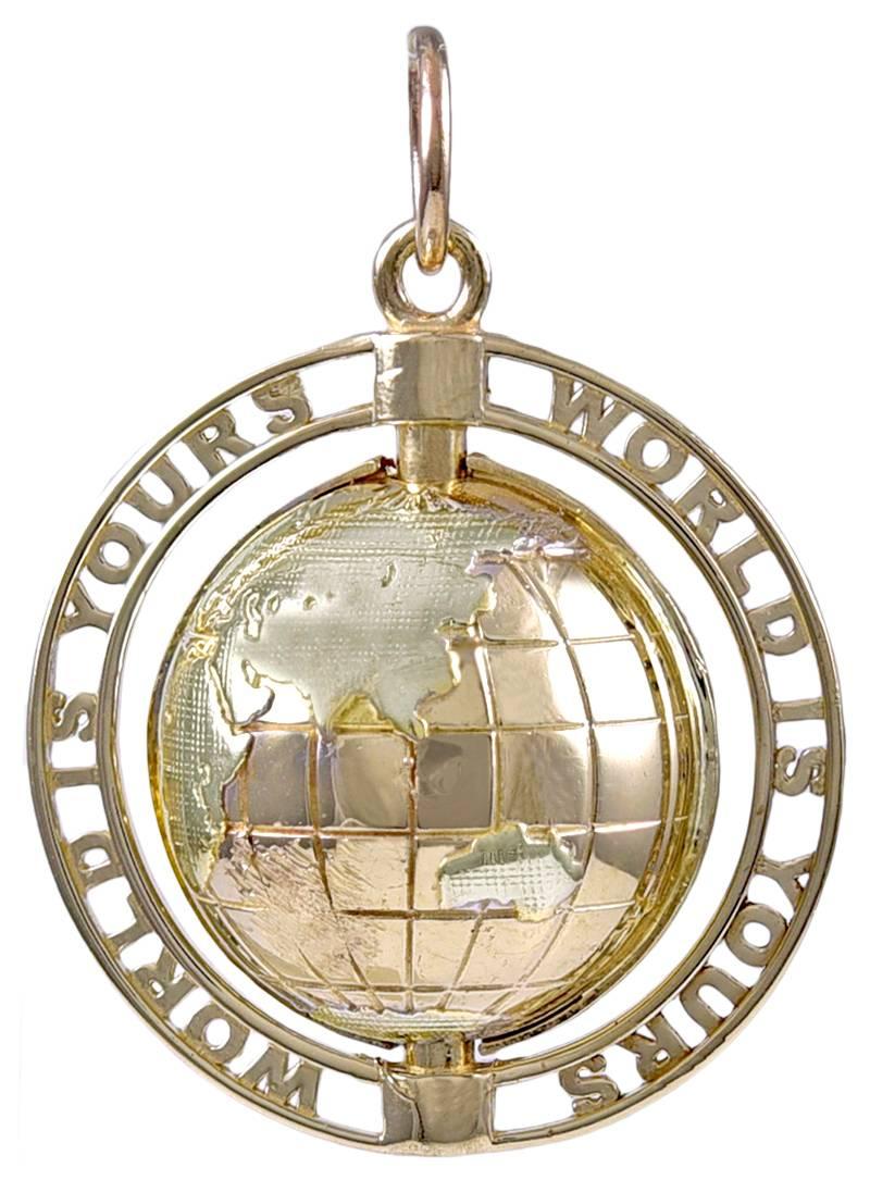 Wonderful charm:  a figural "globe" charm.  Thee globe is set in the middle and it spins.  Around the border,  spelled in cut-out letters is "World is Yours." 1 1/4" in diameter.  14K yellow gold.   Great message, great