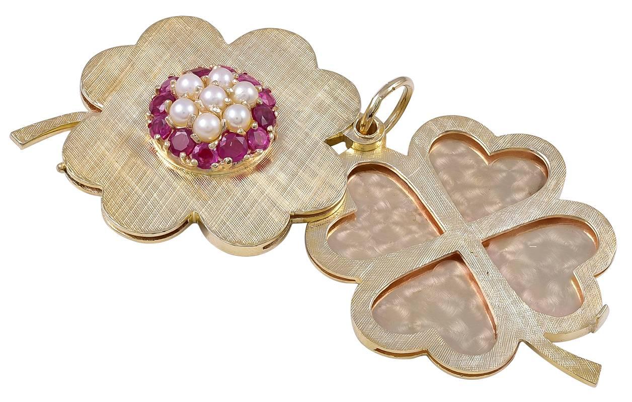 Large figural "four-leaf clover" locket.  With a central applied cartouche of brilliant faceted rubies and seed pearls.  Opens to reveal eight heart-shaped bezels.  Almost impossible to find lockets for eight picture.  Heavy gauge textured