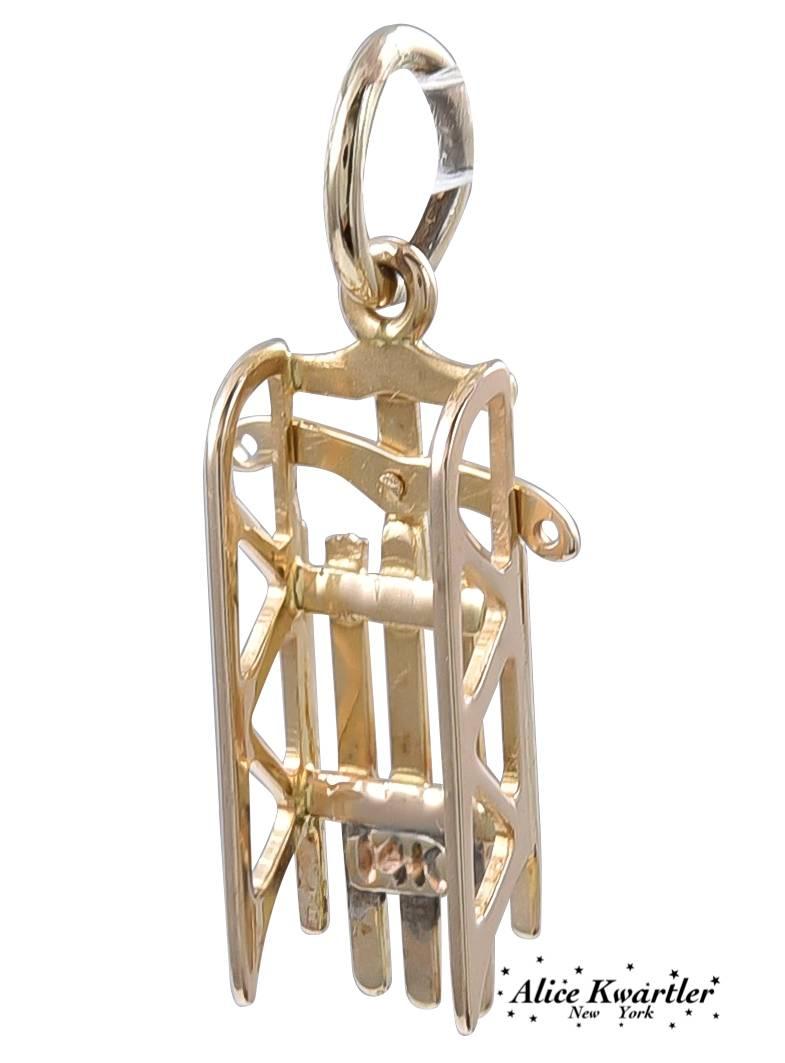 Figural "sled' charm.  Moveable rudder.  14K yellow gold.  3/4" long.  A rare subject.

Alice Kwartler has sold the finest antique gold and diamond .jewelry and silver for over forty years