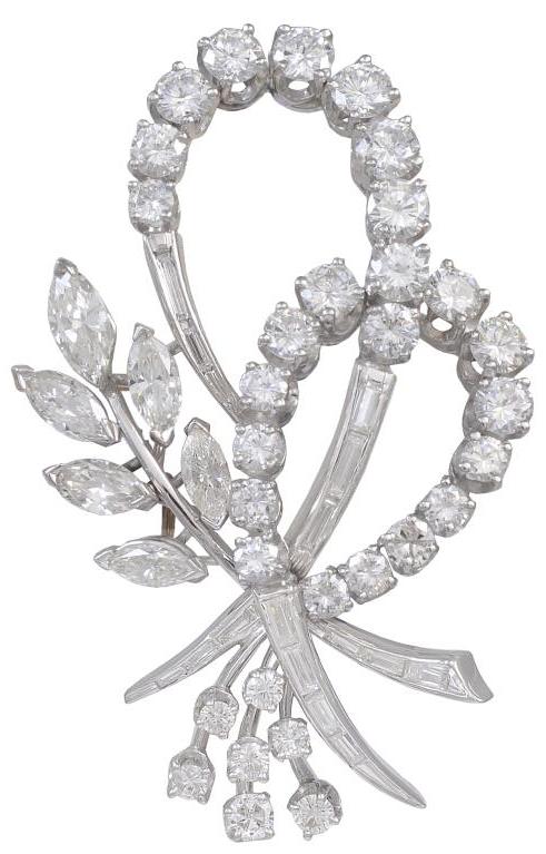 Feminine, sparkling diamond brooch. Set in platinum with 5.50 cts of full-cut round, marquise and baguette diamonds. 2