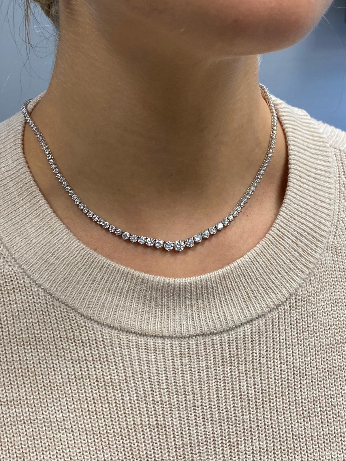This exquisite graduated riviera necklace set in handmade 18k white gold featuring perfectly cut ideal round brilliant diamonds. the super white diamonds are in E-F color and VVS to VS clarity with a total carat weight of 10.71.
the center stone is