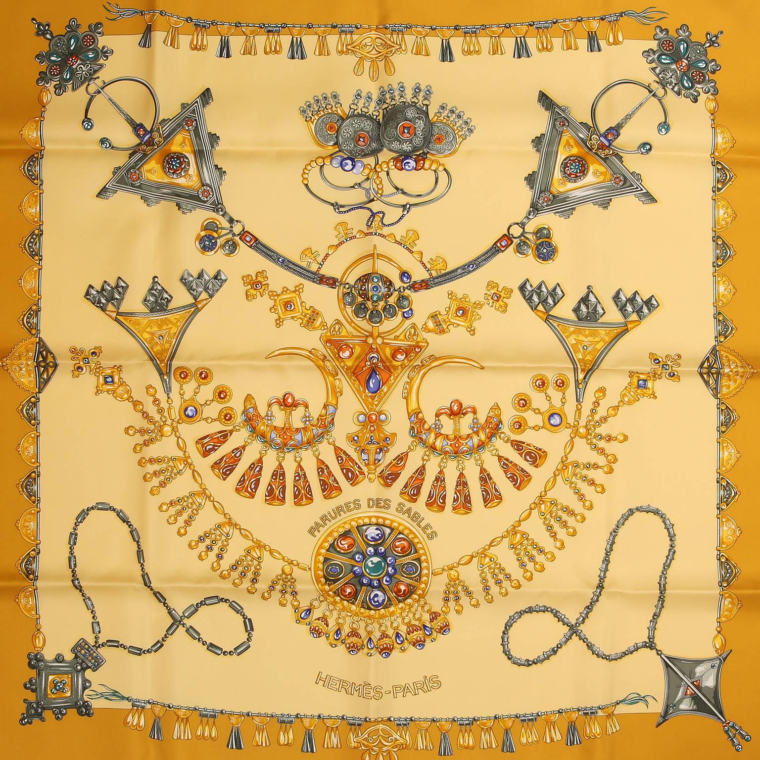 Hermès Parures des Sables 90 cm Silk Scarf - New in Box
Designed by Laurence Bourthourmieux.  Gold border with a pale yellow background.  Design features Eastern influenced ornaments, jewels and tassels.   Made in France.  100% silk.  35”
A443
