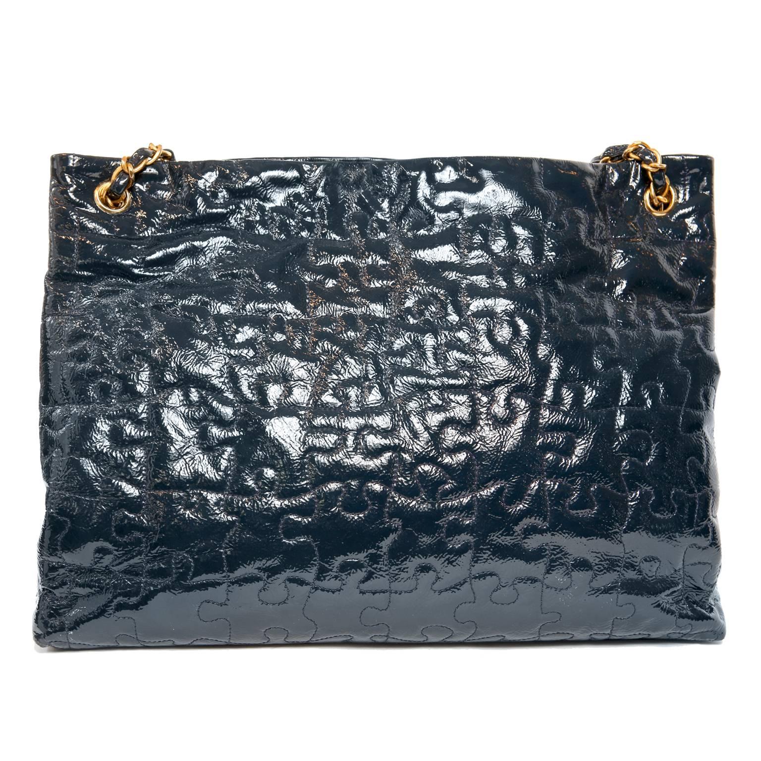 Chanel Navy Patent Leather Puzzle Tote- Pristine
Spacious and durable, Chanel’s Navy Blue Patent Puzzle Tote is perfect for daily enjoyment.
Navy Blue patent leather is stitched in a jigsaw puzzle pattern.  Double leather and chain entwined straps