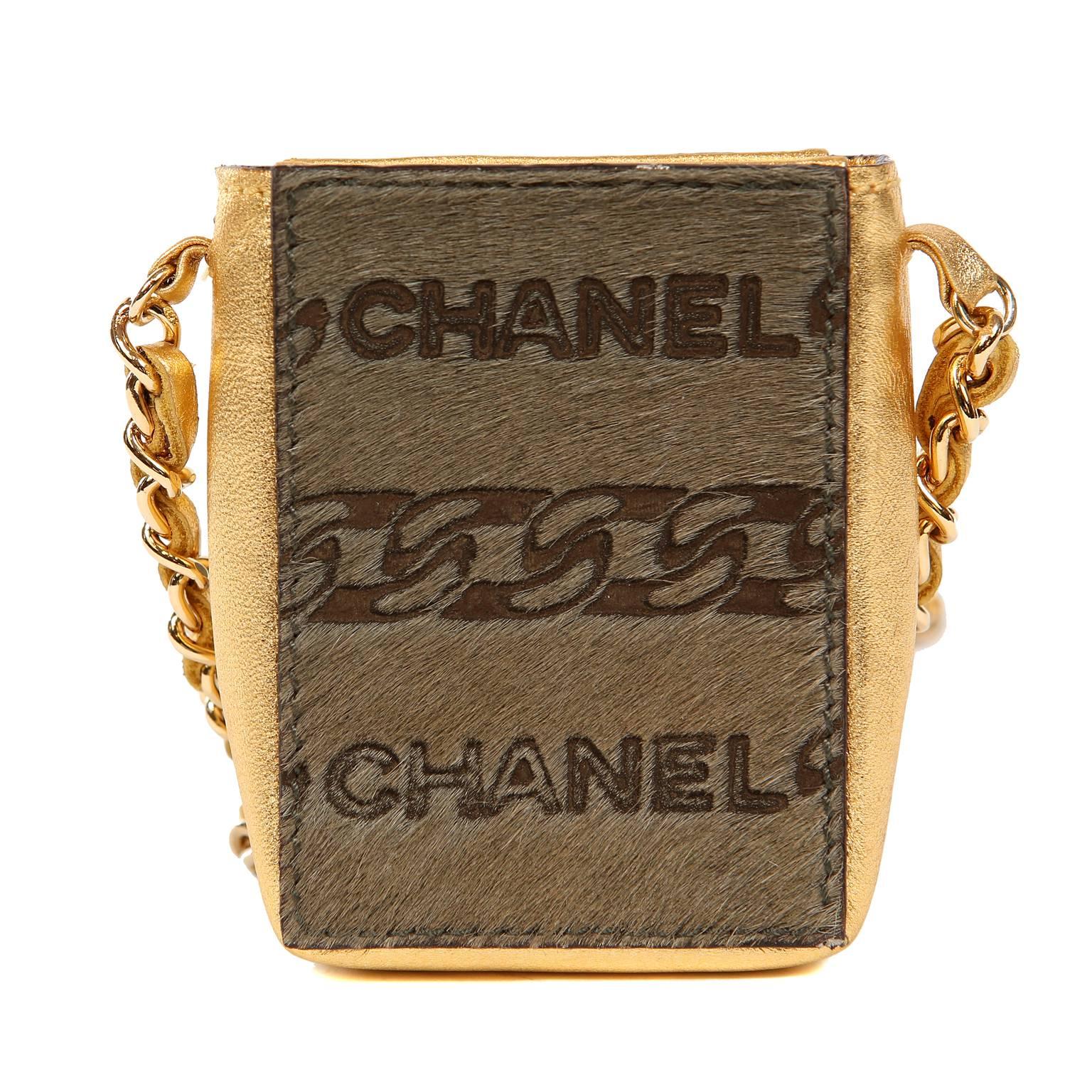  Chanel Gold Leather and Calf Hair Pochette Evening Bag- Pristine
Collectible miniature evening bag in metallic gold leather and calf hair.  Extra long leather and gold chain entwined strap may be carried cross body.  Made in Italy.  
Intact