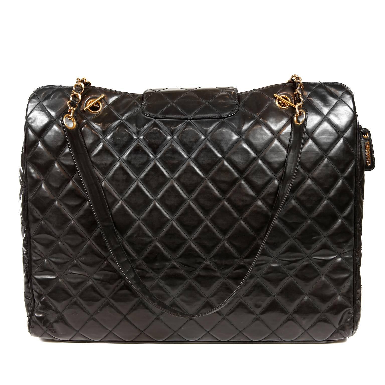  Chanel Black Leather Super Model Vintage Weekender- MINT
Highly collectible unisex travel bag from the 1990’s.  Black polished leather is quilted in signature Chanel diamond pattern.  Zippered top has a secondary flap over closure with large gold