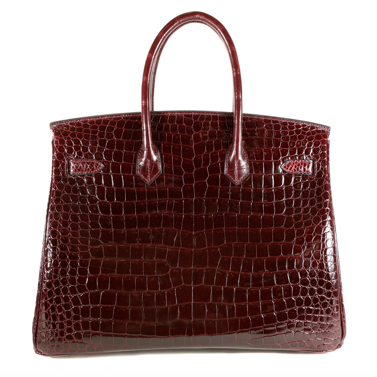 Hermès Bordeaux Porosus Crocodile 35 cm Birkin Bag- Pristine Unworn Condition; never before carried.  
The protective plastic is intact on the hardware and it has been meticulously stored.   Hermès bags are considered the ultimate luxury item the