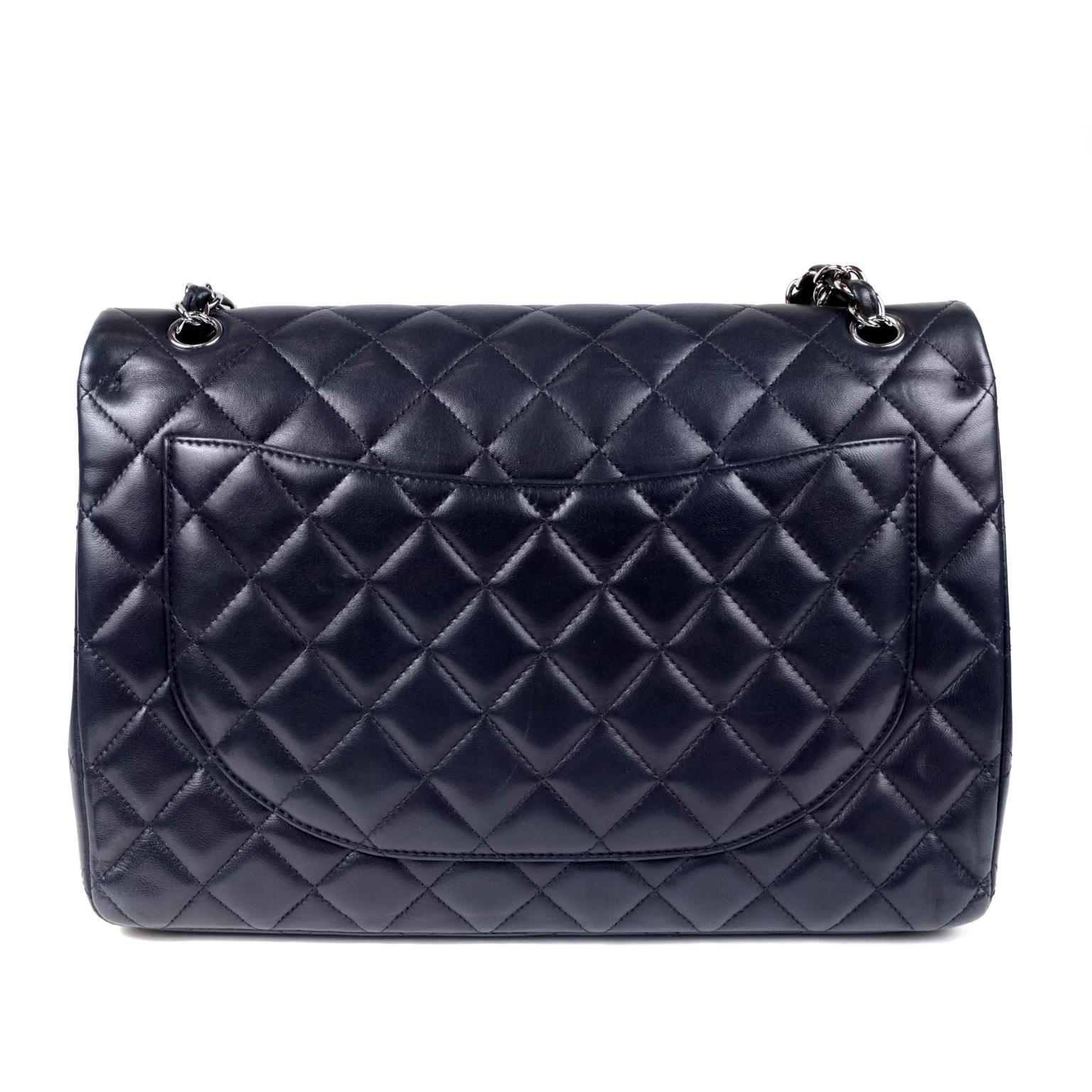 Chanel Navy Lambskin Maxi Classic Double Flap Bag- PRISTINE; Never Before Carried
 Perfectly timeless, navy leather paired with silver hardware in the maxi size is a great addition to any sophisticated wardrobe.  
Rich navy lambskin leather is