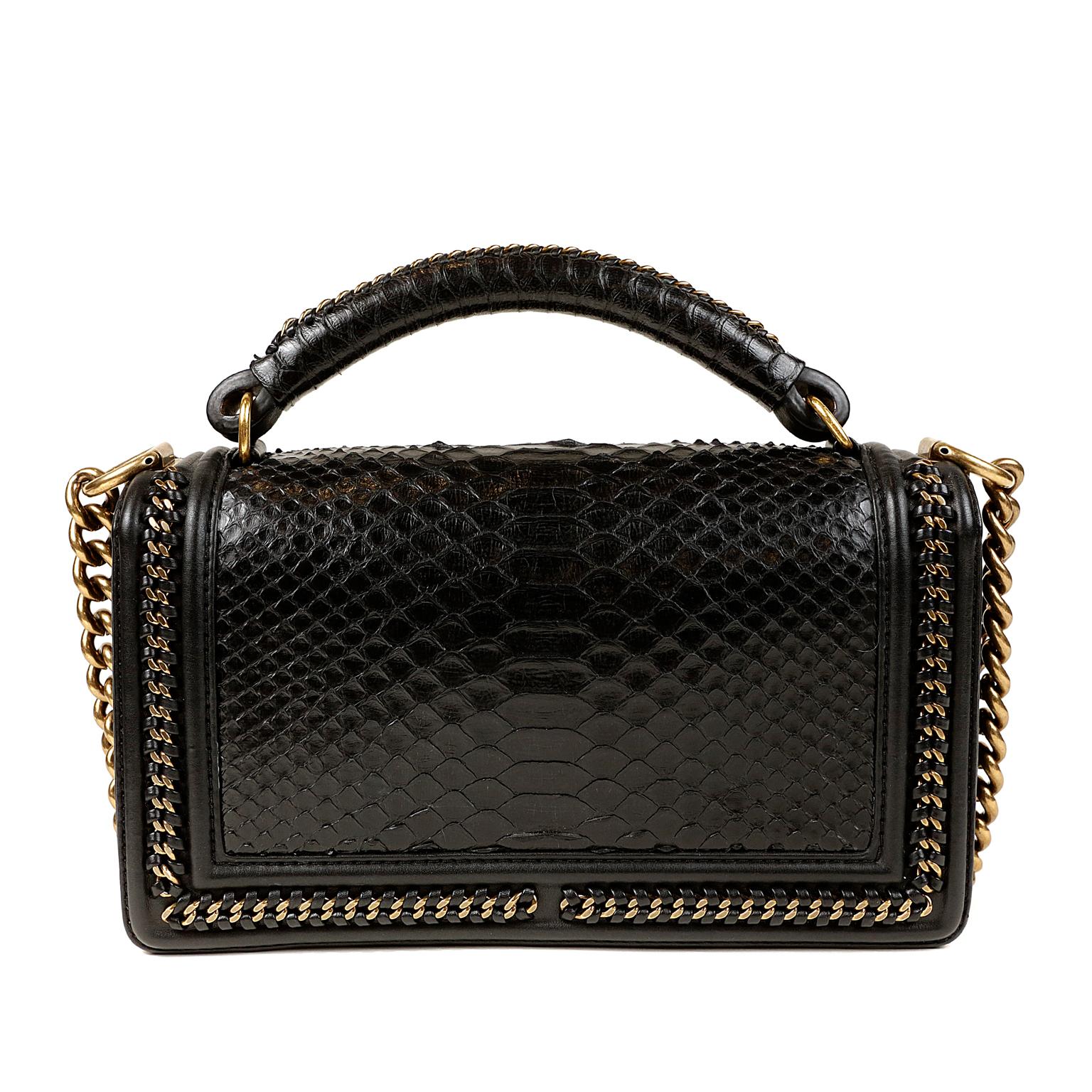 Chanel Black Python Medium Boy Bag - Pristine; appears never carried.     The updated design is structured and edgy with a versatility that makes it extremely popular.  Exotic python, antiqued gold hardware and intricate details elevate this Boy Bag