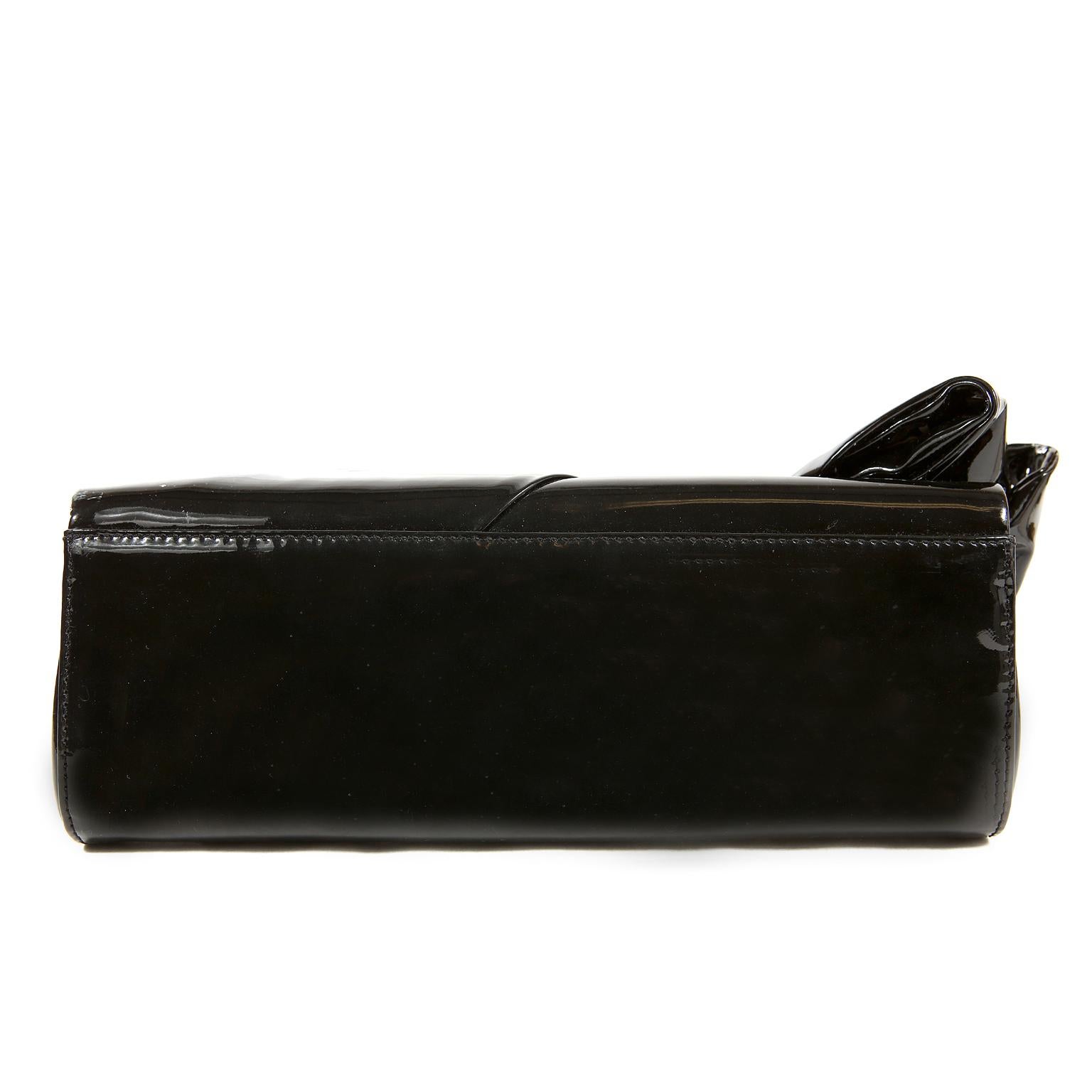 Christian Louboutin Black Patent Leather Bow Clutch- NEW unworn condition
 An elegant clutch, this Louboutin is certain to become a favorite in any wardrobe.
Gleaming black patent leather clutch has a large decorative bow on the front.  Red satin