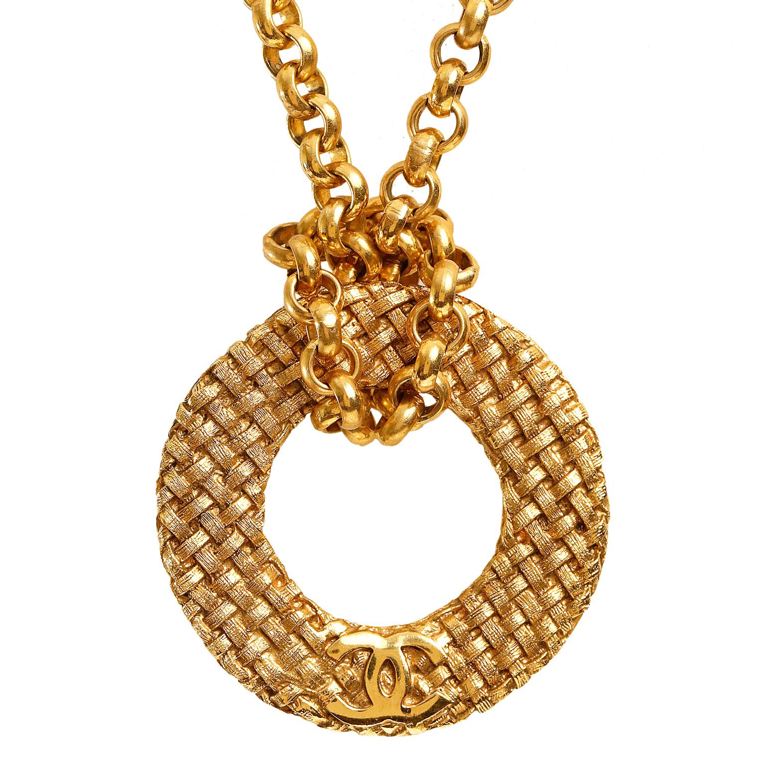 Chanel Vintage  Gold Plated Medallion Long Necklace- mint condition.   From the late 1980’s; collection 29.
Long linked gold-plated necklace loops around a circular medallion with interlocking CC and woven texture.  Spring ring clasp.  Made in