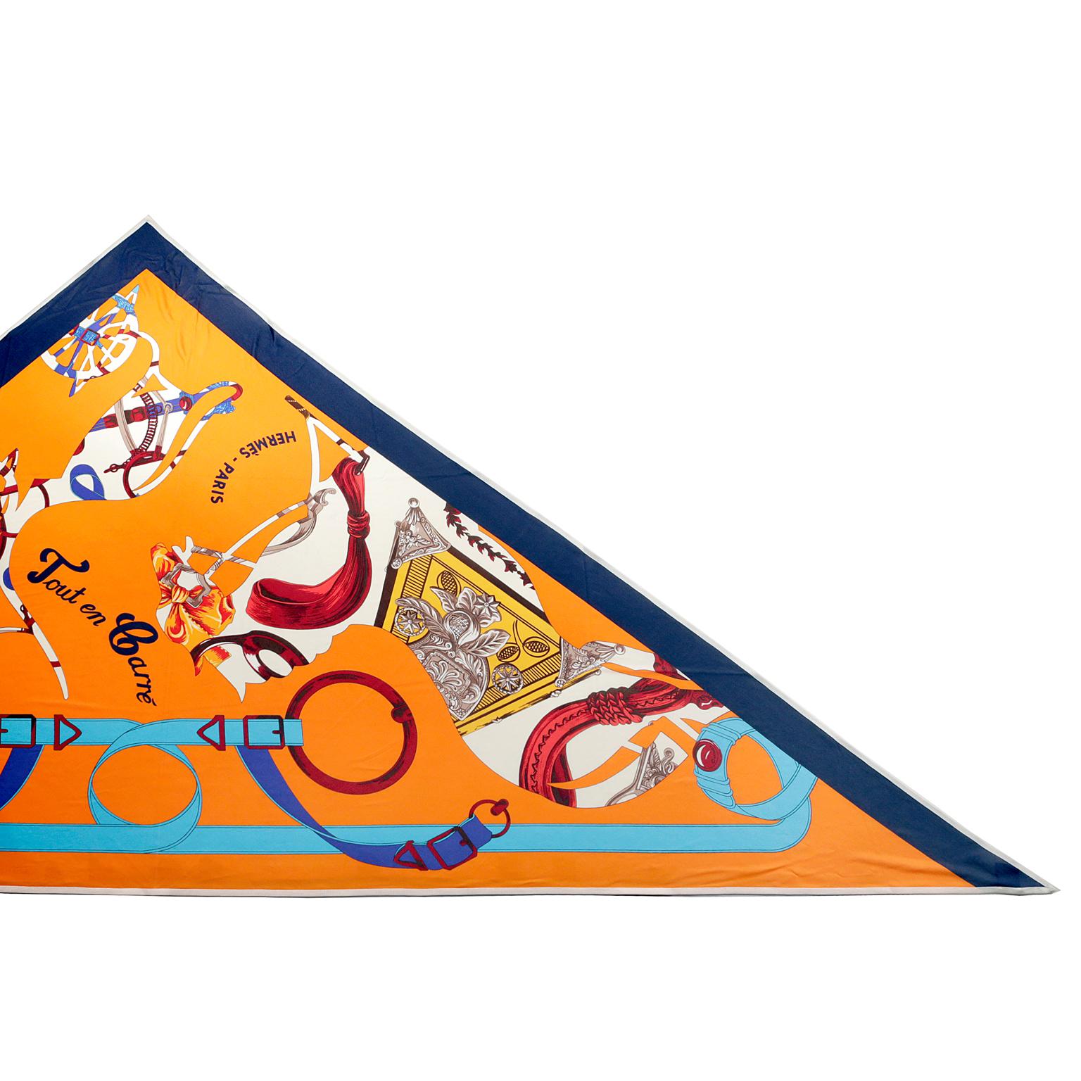 Hermès Tout En Carre Silk Triangle Scarf- pristine condition
Bright orange background with navy blue border and white knit edging.  Equestrian themed designed by Bali Barret and first issued in 2006.   100% silk.  Made in France.
Measurements: 43” x