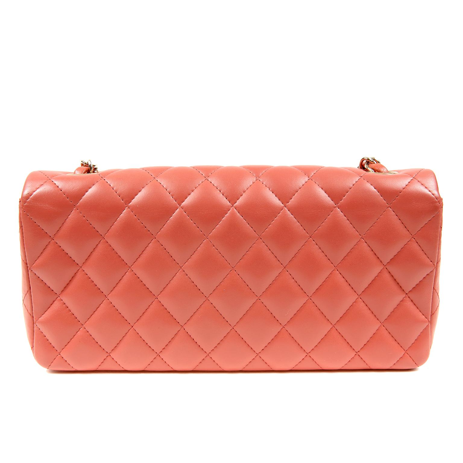 Chanel Salmon Lambskin East West Flap Bag- pristine, appearing never carried.  The captivating color and medium silhouette makes this Chanel a great addition to any collection. 
Corally salmon lambskin is quilted in signature Chanel diamond pattern.