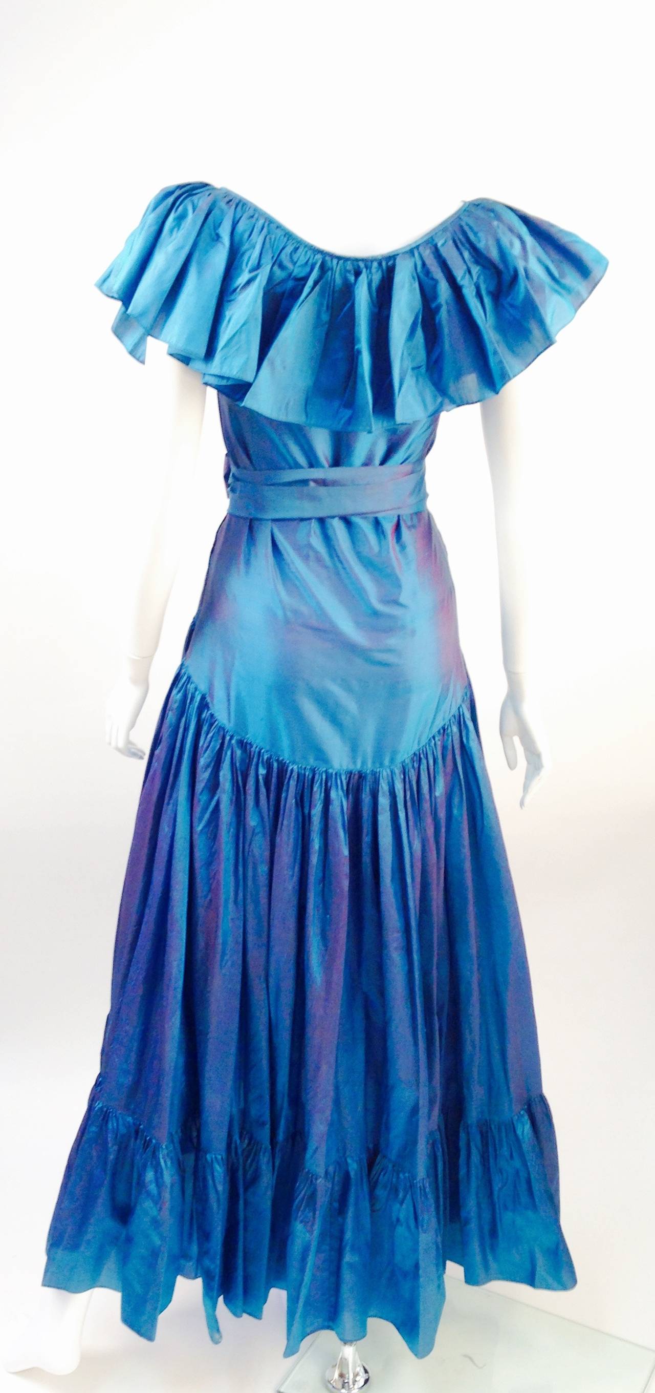 We love this gown!!  The color is so -- beautifully tasteful, iridescently fun, and soothing all the same!  This late 70's early 80's Saint Laurent gown reminds us of the Russian peasant gown meeting up with the new bohemian.  Flowing luminescent