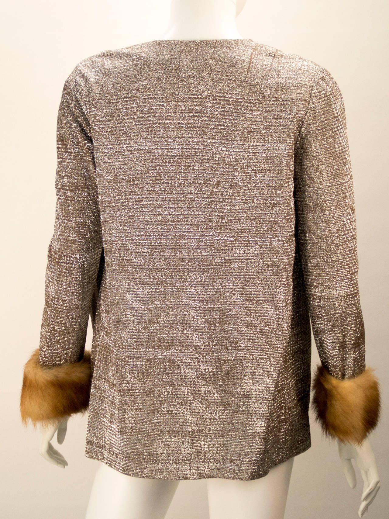 Metallic knit light weight jacket with mink cuffs adds glamour and a warmth to anything your wearing.  This beautiful piece is beautifully lined. Oscar de la Renta and Silver Key/Neiman Marcus labels.

*All garments and accessories have been