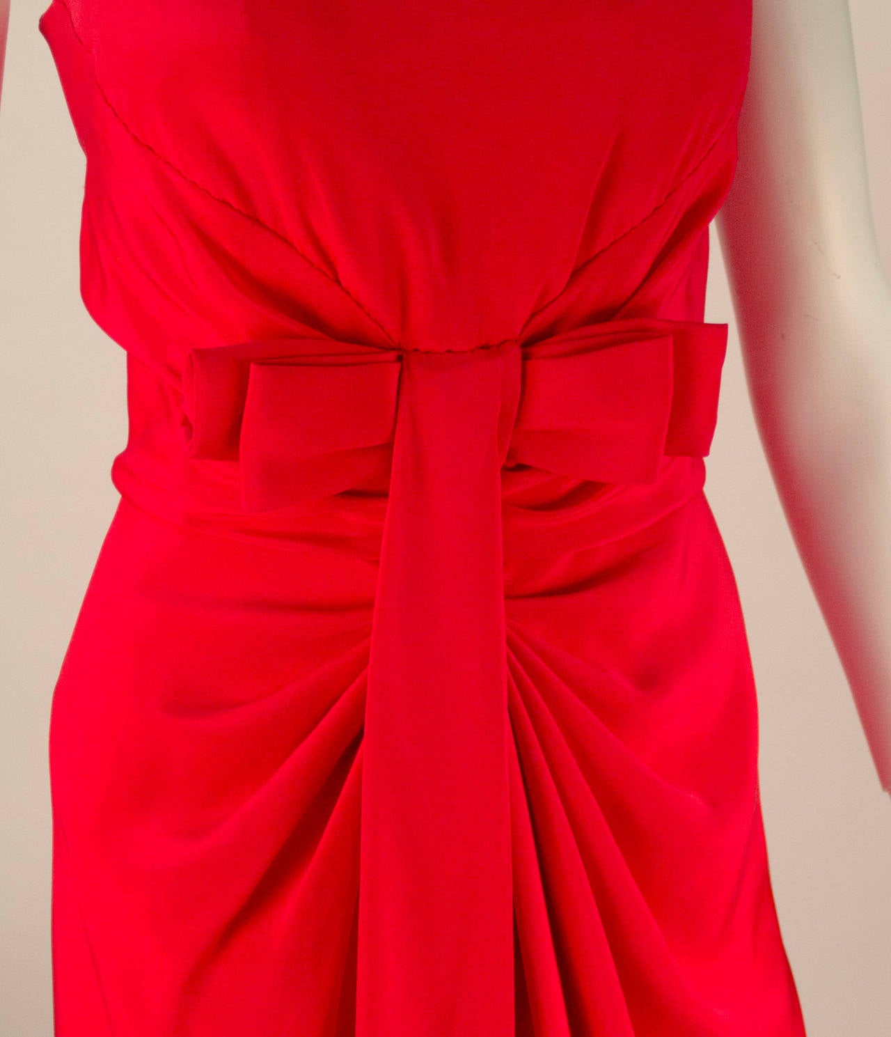 Gorgeous 1990's Red hot strapless dress with a front bow. The bow adds the perfect  feminine touch that this dress needs. Beautifully draped gathers at waist of dress. Dress has a slight slit center front.  Zipper center back with hook and eye