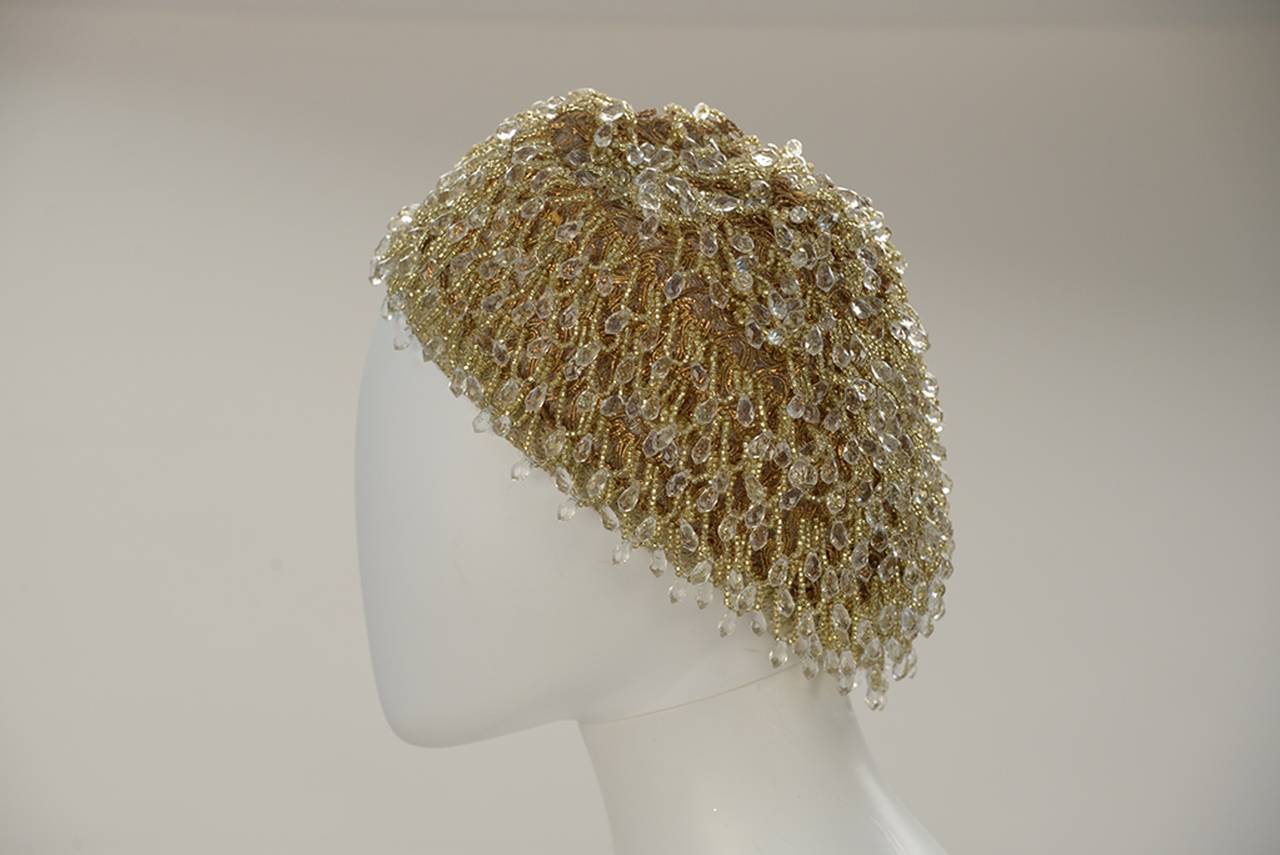 Simply remarkable beret with movement and sparkle and sophistication!  Walk into any room and light it up.  This knock out has gold thread detail and drips clear crystal teardrop shaped beads.  The gorgeous beads fall just so-- as to catch available