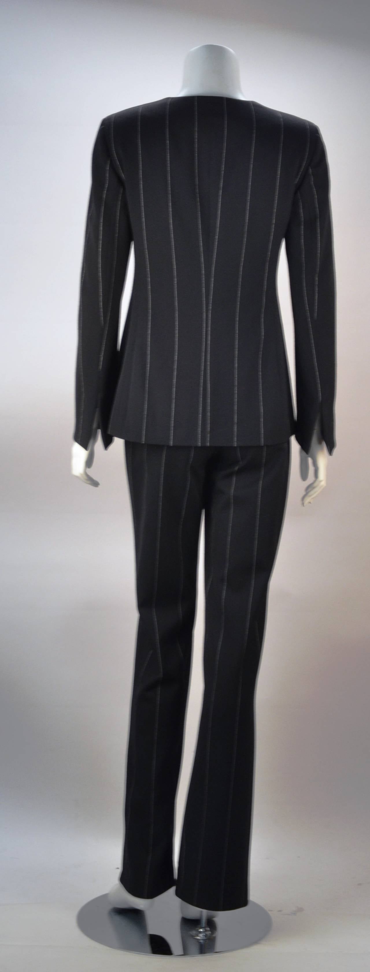 Taste and style in a suit! This figure flattering suit is beautifully designed with wide pin stripes creating an optical illusion. Understated, sexy and modest enough for the office. The square neckline can be worn with or without a collared blouse.