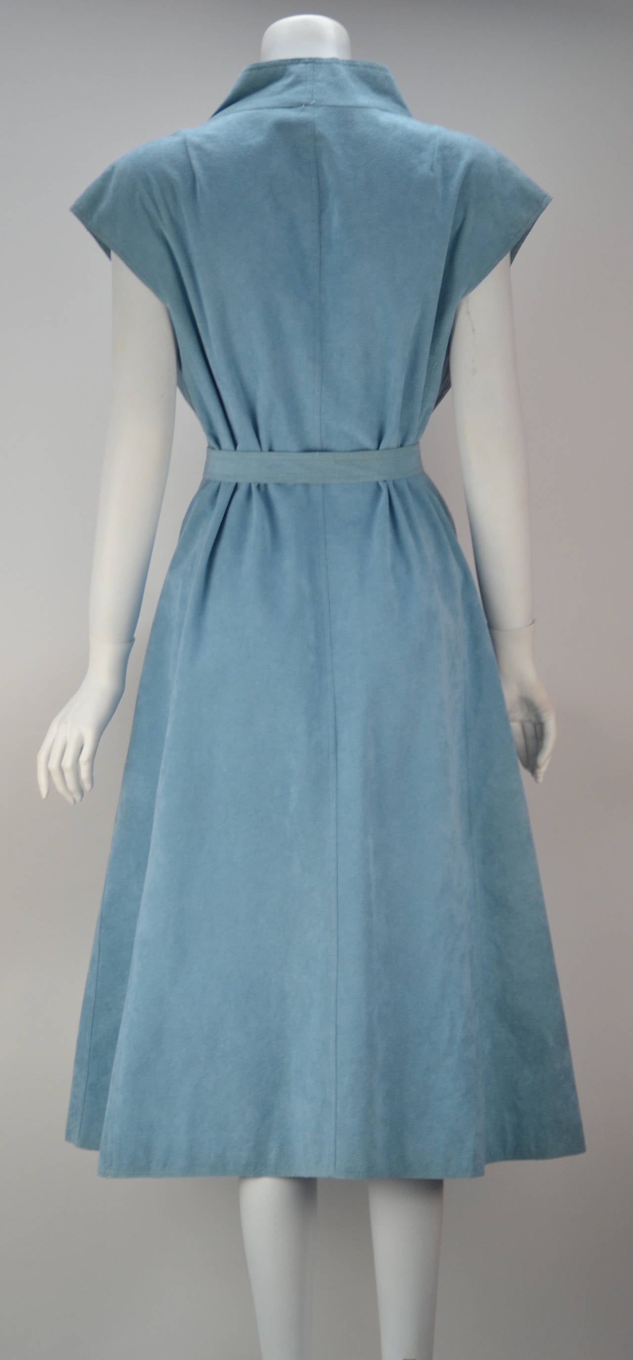 Oh so spring with its sky blue hue and so comfortable Halston!  Sleeveless Kimono style wrap dress with stand up collar. Coordinating sash accentuates the waist in this easy fitting dress. The ultra suede allows for wear as well thoughout the year. 