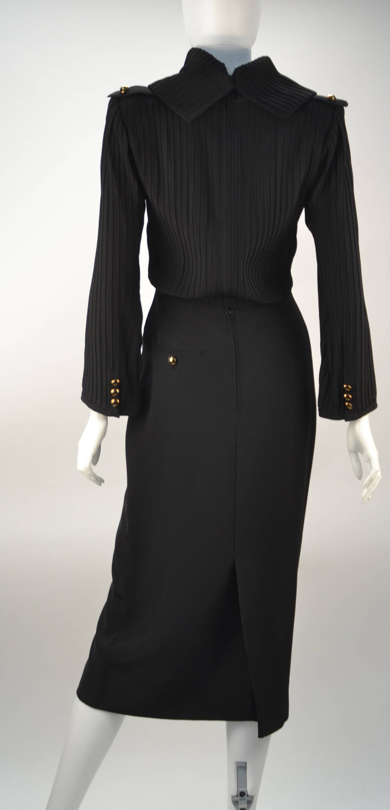 Early Louis Feraud combines both elegance and power. This beauty is comprised of a blousson top with large back pointed cowl neckline and a 