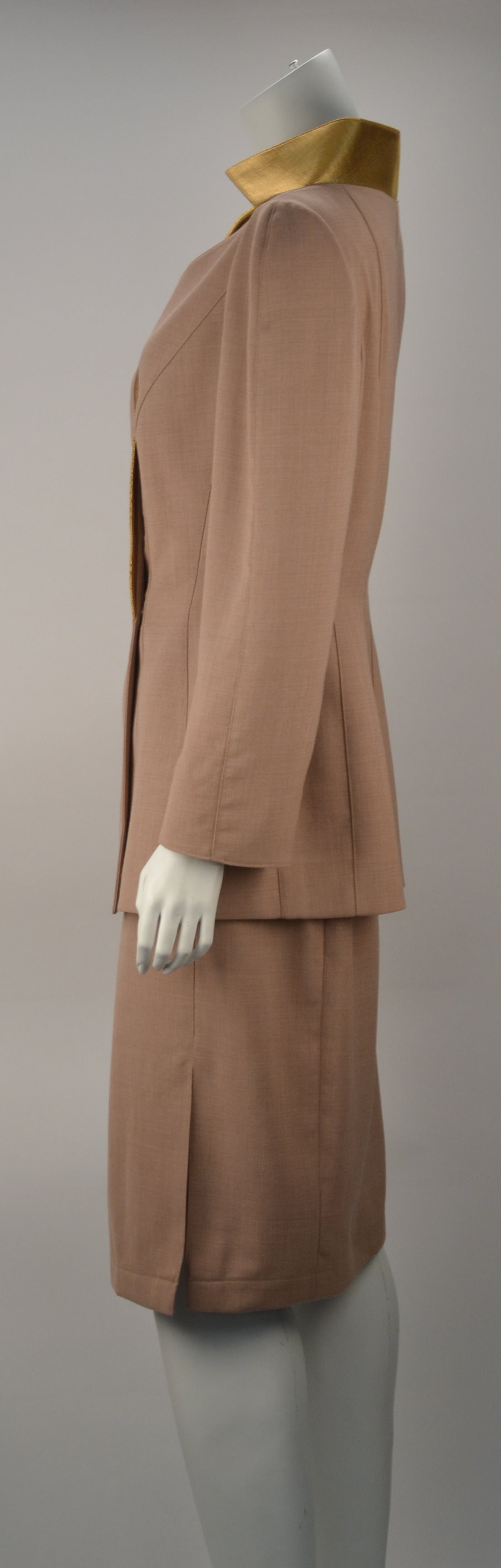 Mugler couture two piece suit. Suit has a lapel that goes around the neckline in contrasting color, v-neck, two buttons on the front. Princess seams for fit on the jacket, full sleeve in beige color. Matching semi fit skirt with side pleat back