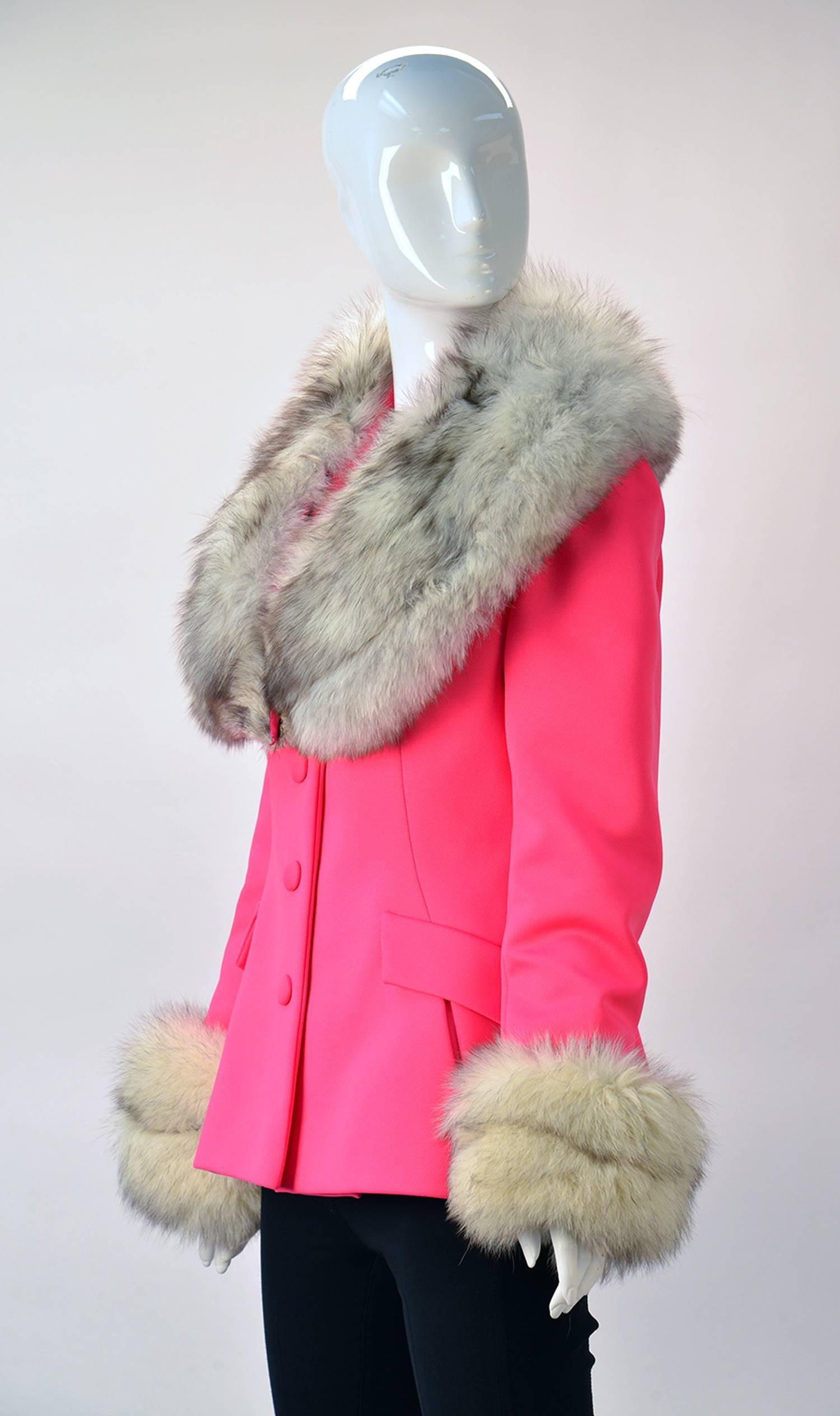 
Fantastic for a cold Sring day comes this 1960's Lilli Ann pink jacket with large fox fur collar and cuffs. The jacket features princess seams, with Spanish snap button holes. Faux pockets with flaps. There is a snap to close the fur. The back of