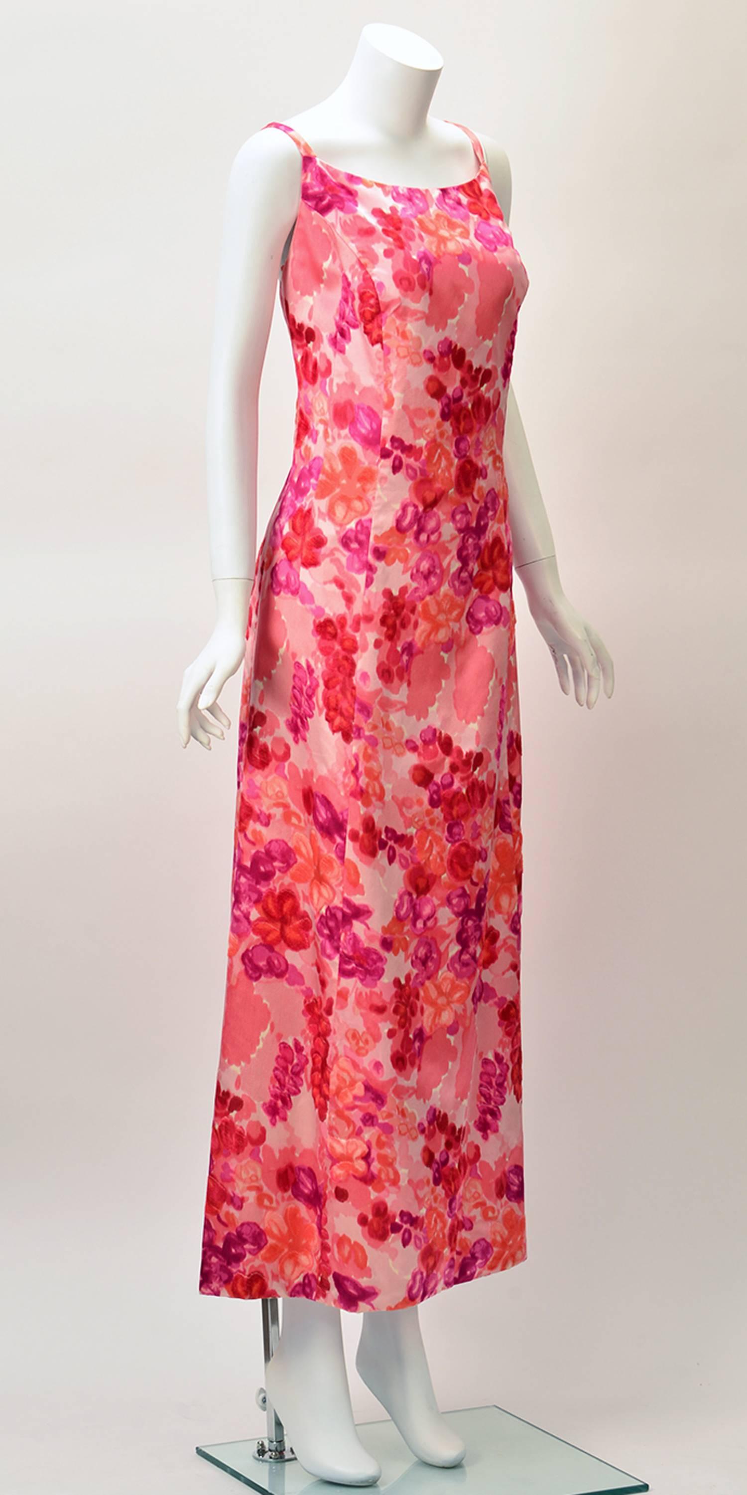 
Perfect for spring and summer comes this 1964 silk satin salmon pink evening gown with velvet flowers.  The floral motifs are velvet in berry colors.  Square neckline with an open back. Dress features princess seams. Zipper center back. 
 
Modern
