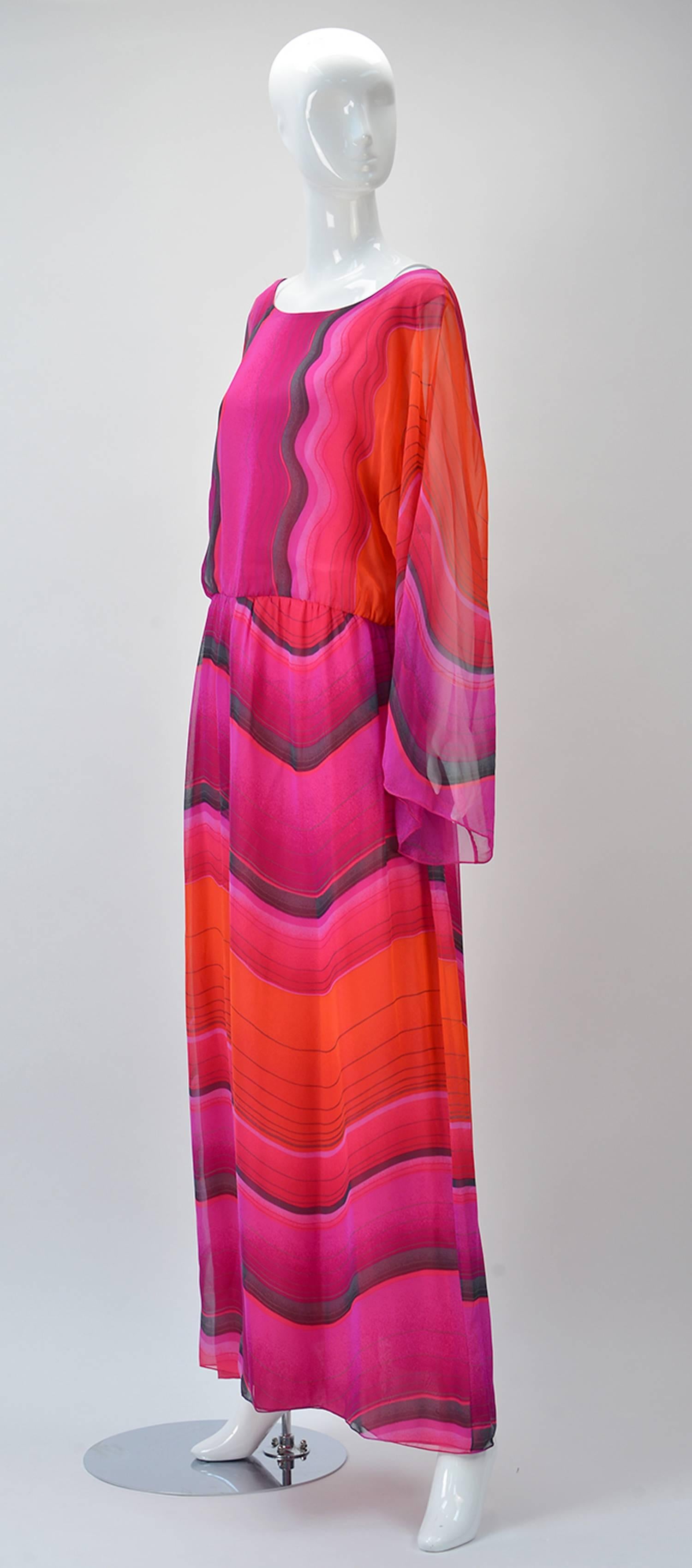 
Hana Mori is known for her delicate silk dresses and this one is spectacular. The print could have been inspired by Red Rock Canyon in Nevada with reds pinks and grays. The length of the dress is maxi depending on your height. Extra long sleeves