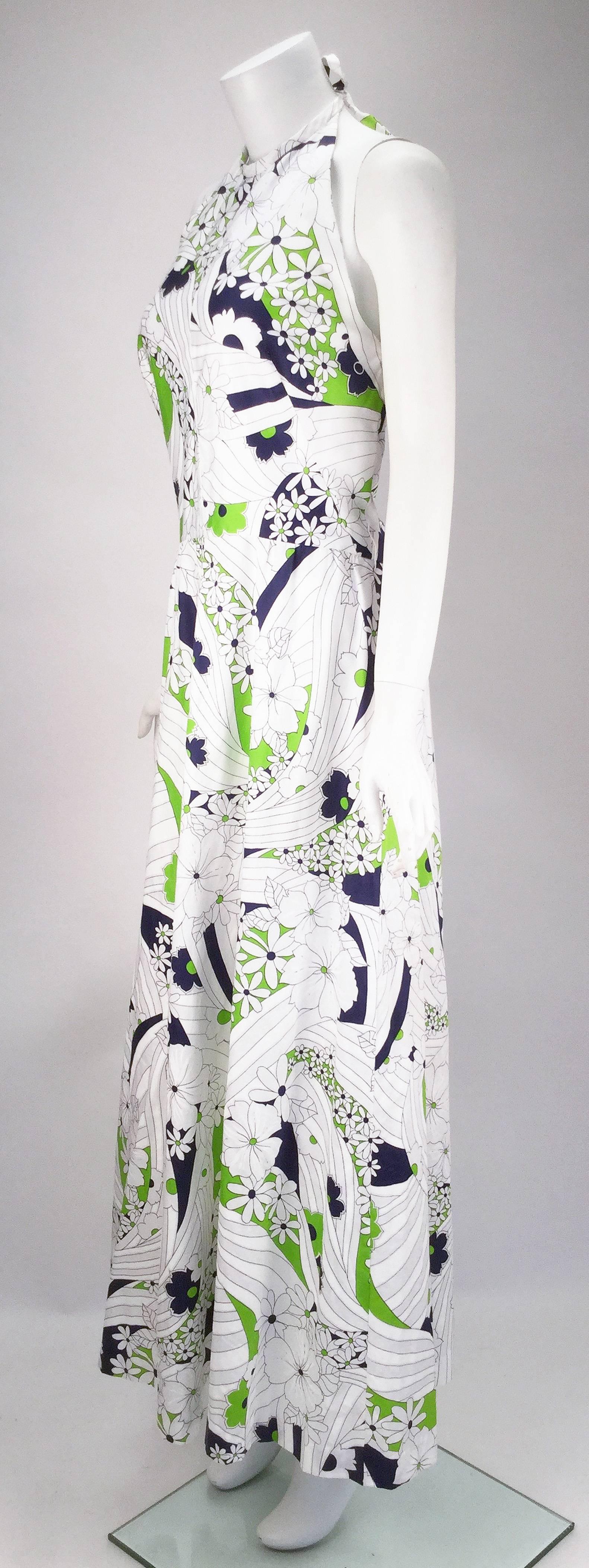 This 1970s halter maxi dress from historic golf sportswear company, Gregg Draddy is perfect for your active summer lifestyle!!!  Dress is white with navy and green floral patterns throughout the dress and thin enough to keep you cool on those