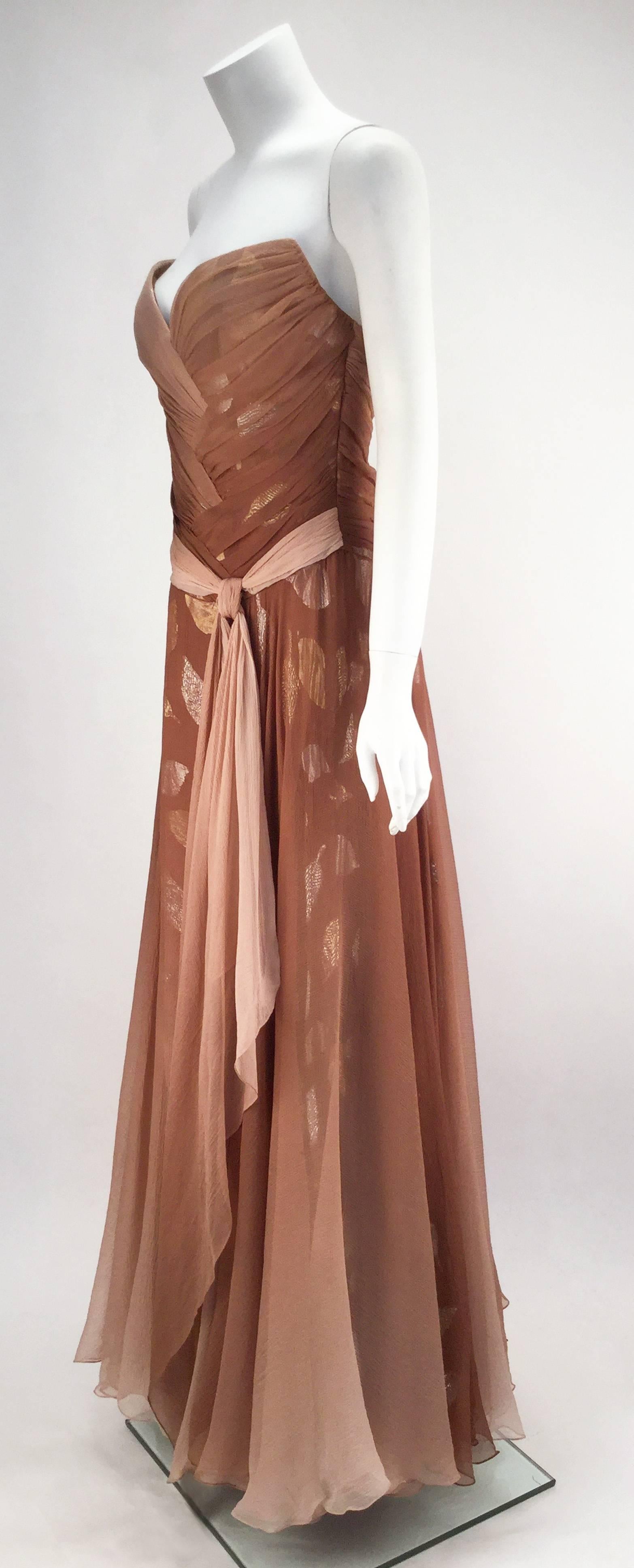 Hues of taupe ombre silk crepe create an ethereal effect throughout this flowing strapless gown.  The ruched bodice has a sweetheart neckline, boning and is fully lined. The skirt is made up of layers of ombre silk crepe and ombre silk crepe with