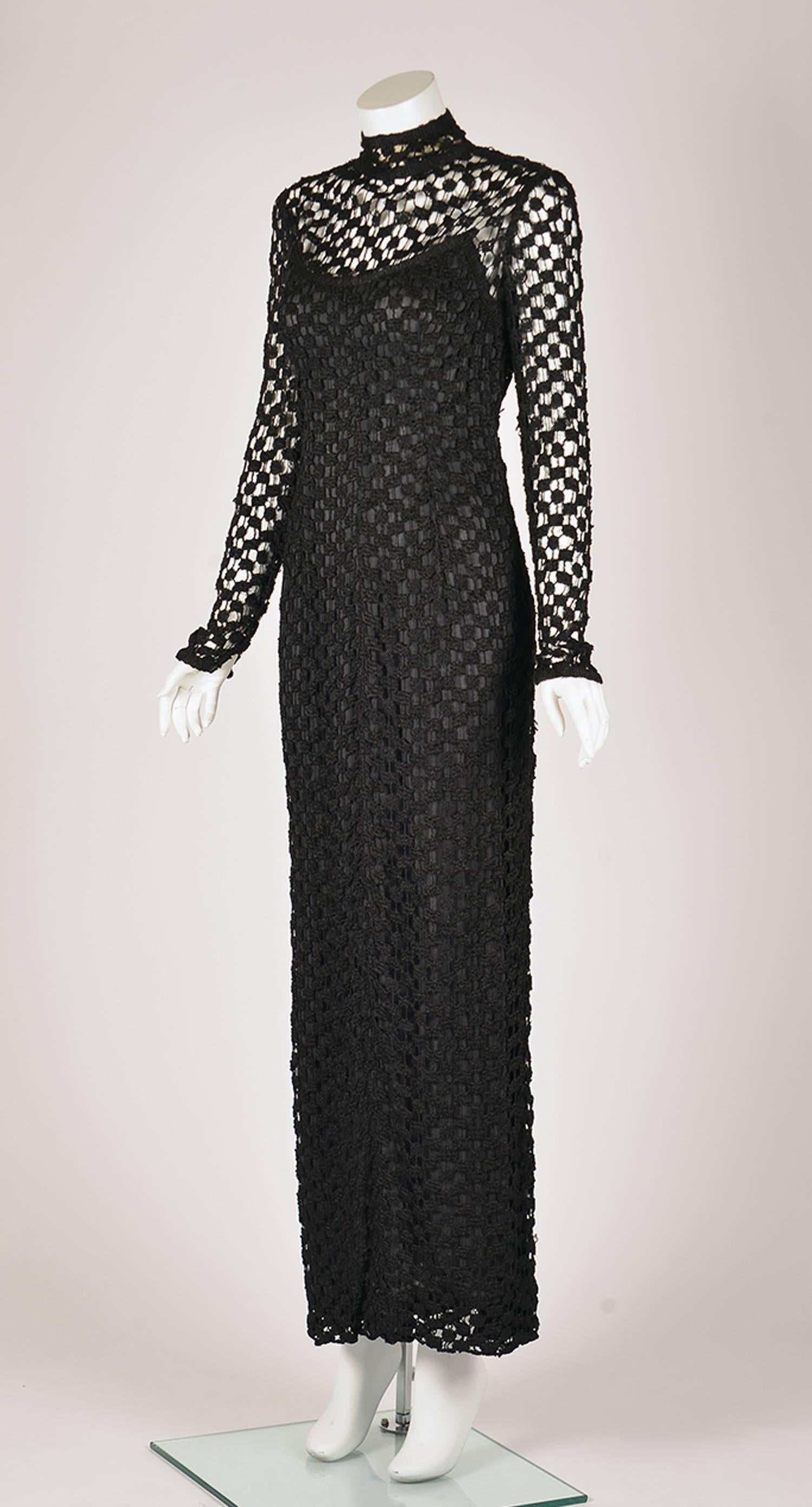 
Beautiful Black crochet dress from Pat Sandler. High standing collar. The decolletage and sleeves are unlined. Decorative rhinestone buttons run from the collar down to mid back but the closure is actually with six hook and eyes.  Lower back