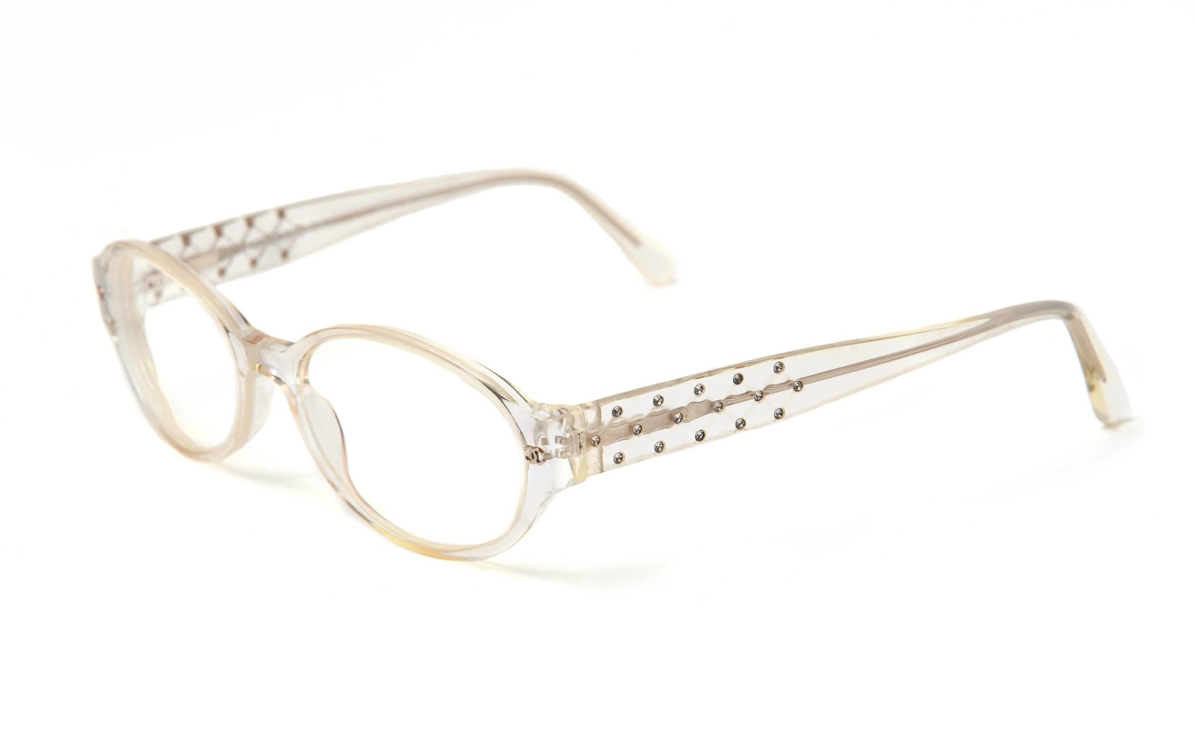 Clear Chanel Rhinestone Eyeglasses. Made in Italy. C185865E. 3050-B. 660. 52/17/135. 

Vintage Chanel glasses. These crystal-clear Chanel glasses have a thick, high-set bridge, and feature crystal rhinestones on the sides of the frame. 
The