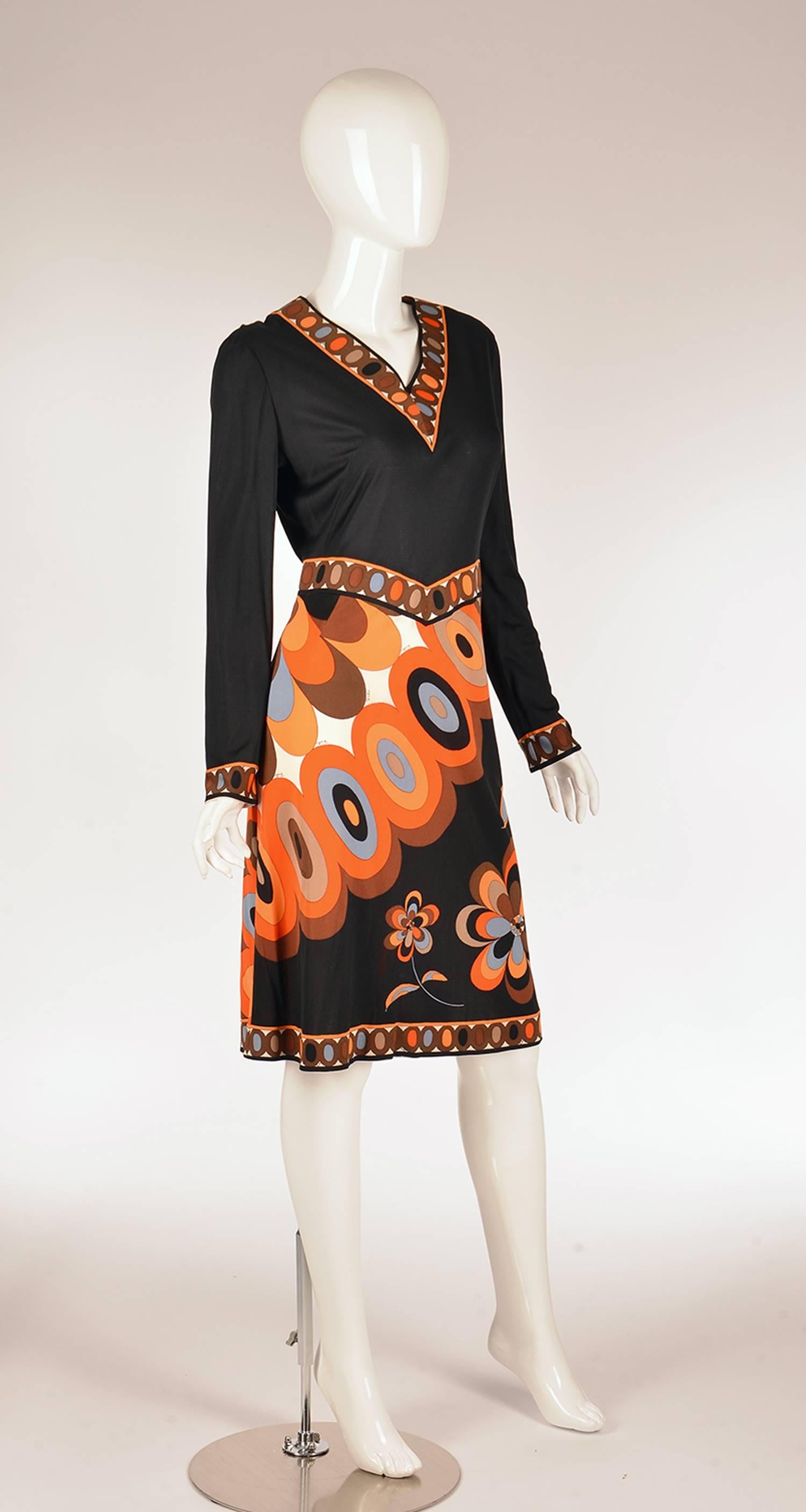 1960s Emilio Pucci silk dress. This dress features gorgeous fall colors - pale blue, walnut, chocolate, fire orange, cream, and red- arranged effortlessly in an oval floral design. The print on this dress is intrinsically Pucci, as the abstract