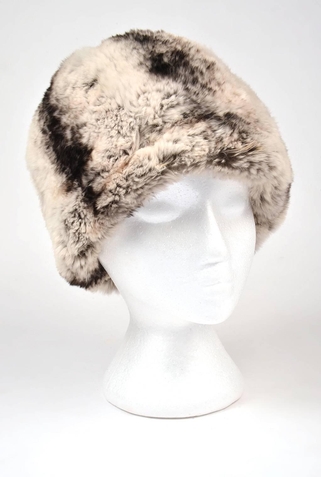 
Warm, Comfortable, and irresistibly plush. This vanilla, cream, and charcoal ink chinchilla fur hat is one that you'll love. The hat features an organic star-like shape at the top of the hat, with dark tips that extend further towards the bottom.