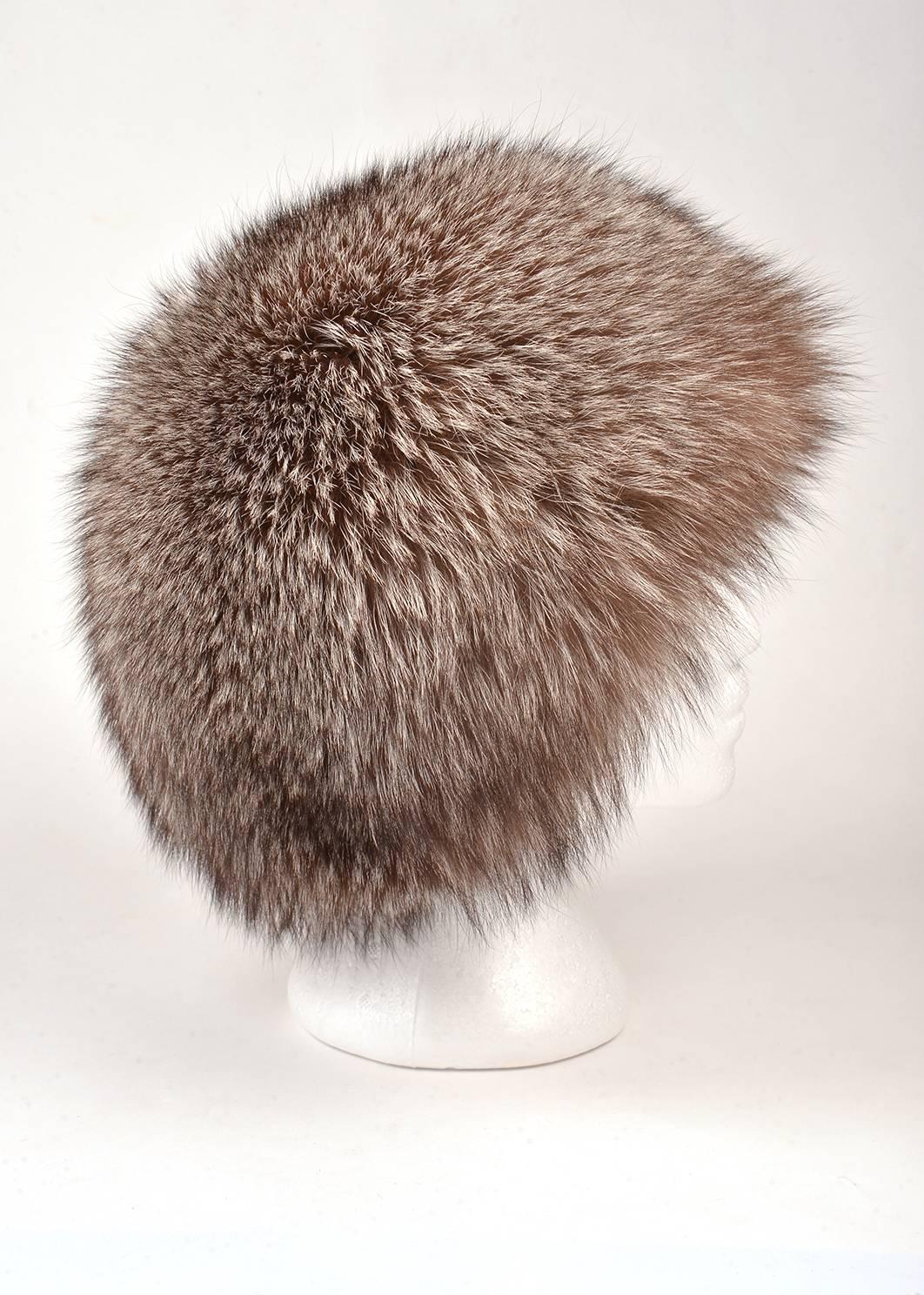 
Irresistibly soft, comfortable, and warm fox fur hat. Mixtures of white, light and dark shades of brown are found throughout the hat, as well as dashes of white, thrown in like a hail storm throughout the fur. 

Circumference: 20 1/2, Diameter: 6