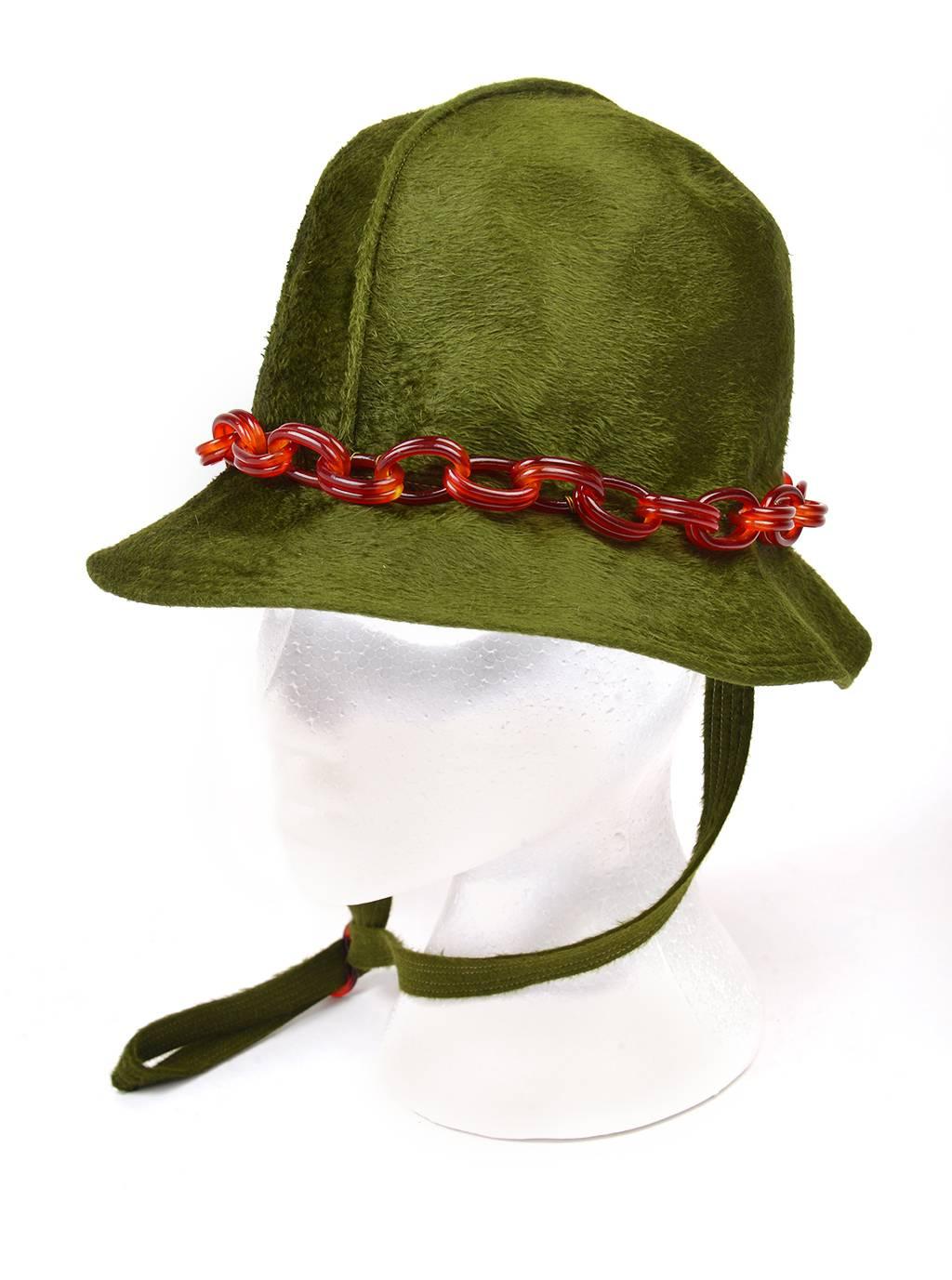 
Funky 1970s Mr John Jr Trevi bucket hat. This wide-brimmed hat is accented with a stitch ridge running front to back, a well as a tortoiseshell oval link Lucite chain band, and a tortoiseshell Lucite neck toggle. The hat is soft and sleek, and