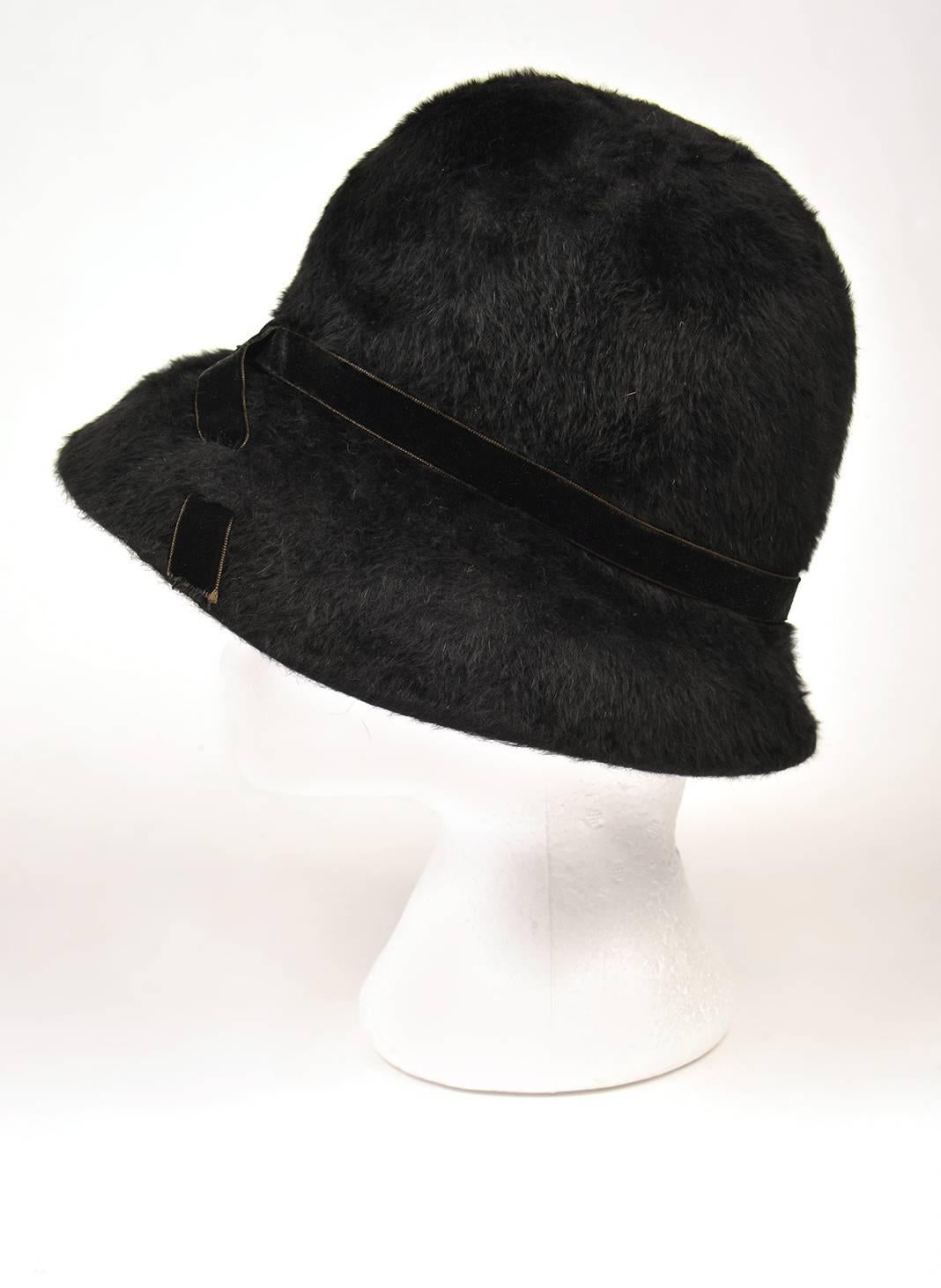 So Now!  Looks like it just walked off the Marc Jacobs runway show at New York Fashion Week.

This fantastic, wide-brimmed, soft and sumptuous faux fur cloche hat by Mr. John - Matador features an elegant velvet ribbon band that crosses over in the
