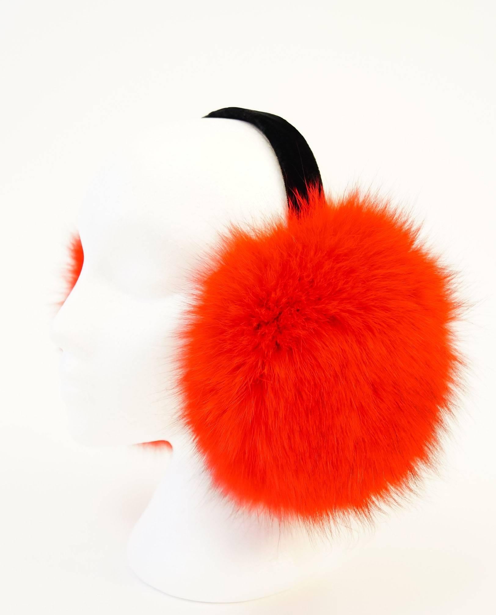 
Luxurious custom made red dyed fox earmuffs for a New York socialite can be owned by anyone in any city.  These earmuffs feature sumptuous red-dyed fox fur on the outer side of a soft black velvet pad, held together by a black velvet headband. The