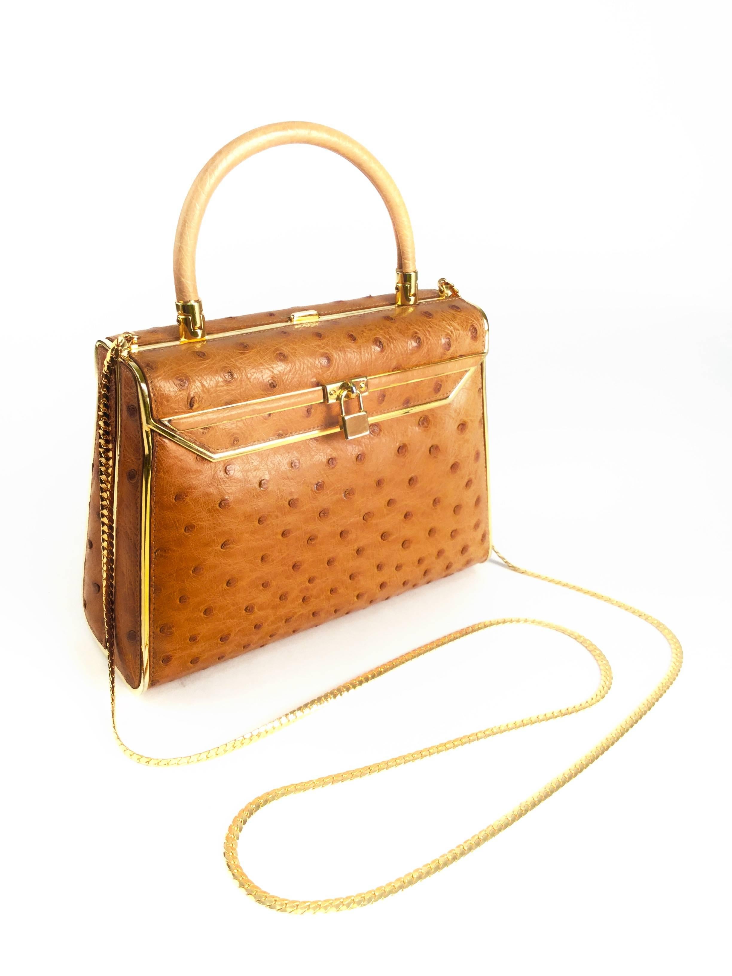 Vintage Finesse la Modele Top Handle Gold Ostrich Handbag

Absolutely wonderful vintage handbag by Finesse la Modele! This top handle purse has a rigid gold tone frame covered by beautiful, soft, caramel color ostrich leather, faux flaps on both