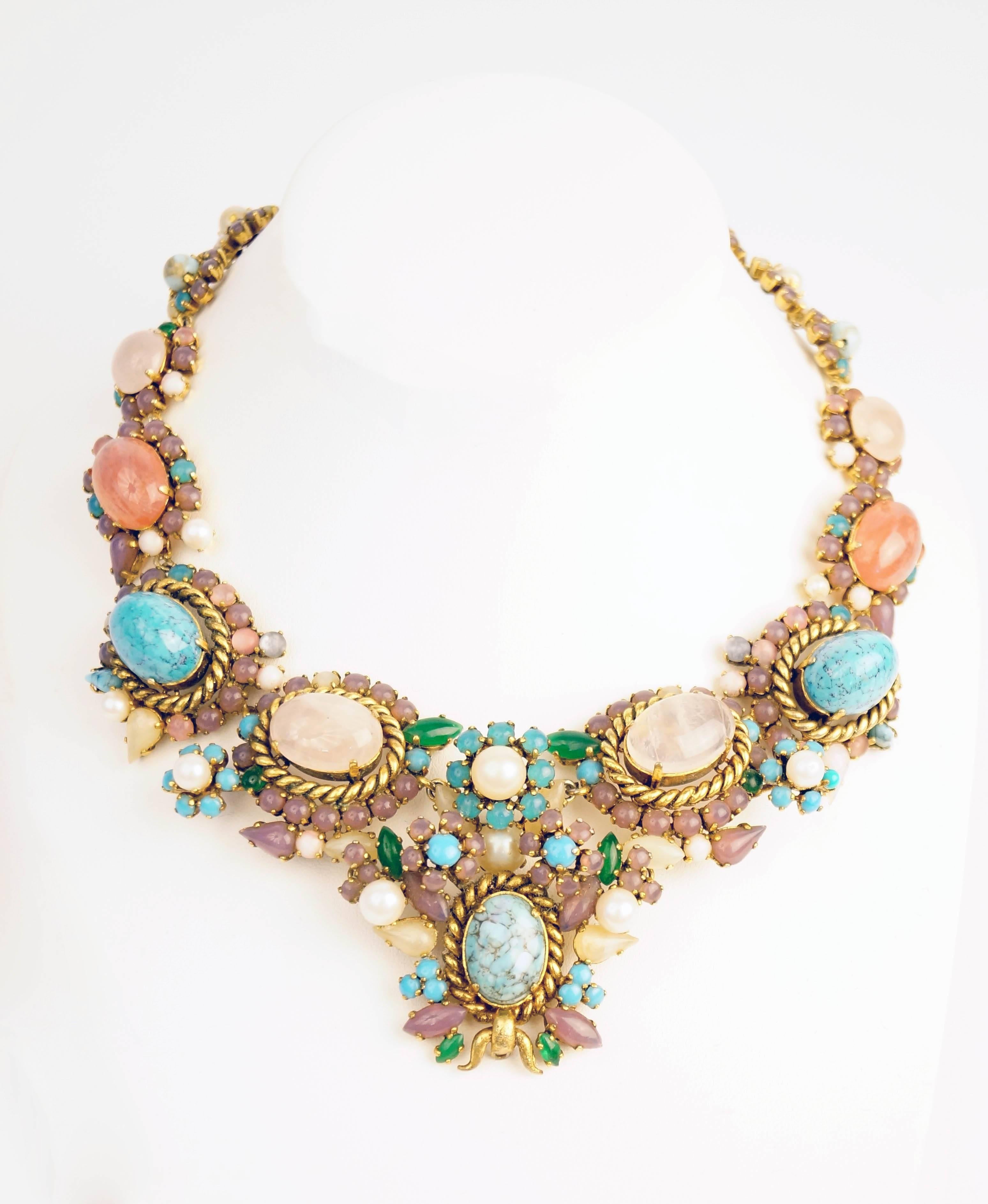 Stunning necklace by Christian Dior, showcasing faux turquoise and rose quartz cabochons surrounded by an elegant and playful assemblage of round and marquise-cut cabochons in purple, pink, green, and pearly white. This necklace of substantial
