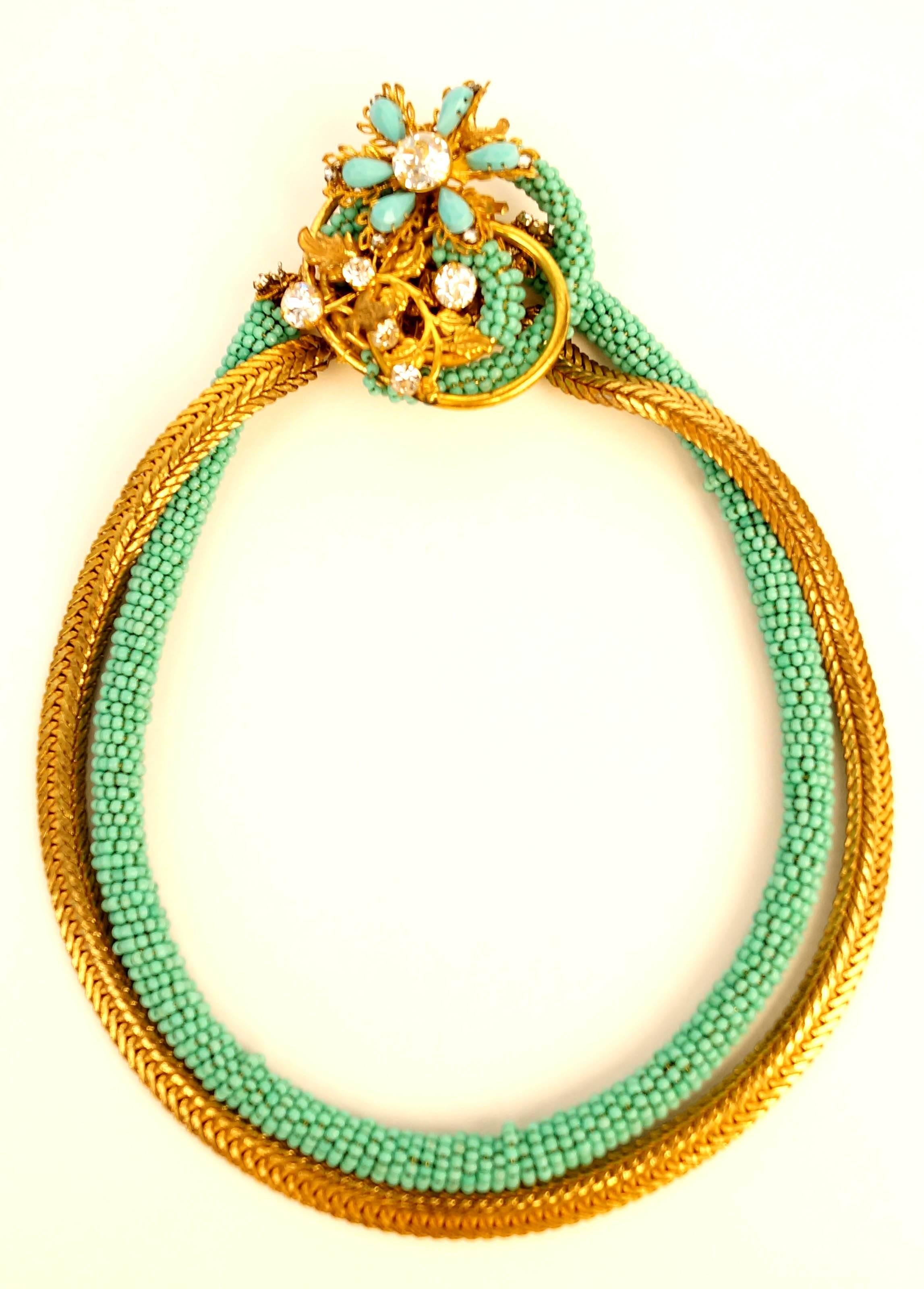 Spring has Sprung!!!!

This grand parure consists of a necklace, bracelet, brooch, and pair of earrings in glorious faux turquoise and gold. The necklace consists of a chain of of wrapped beads and a chain of circular gold-tone herringbone that wrap
