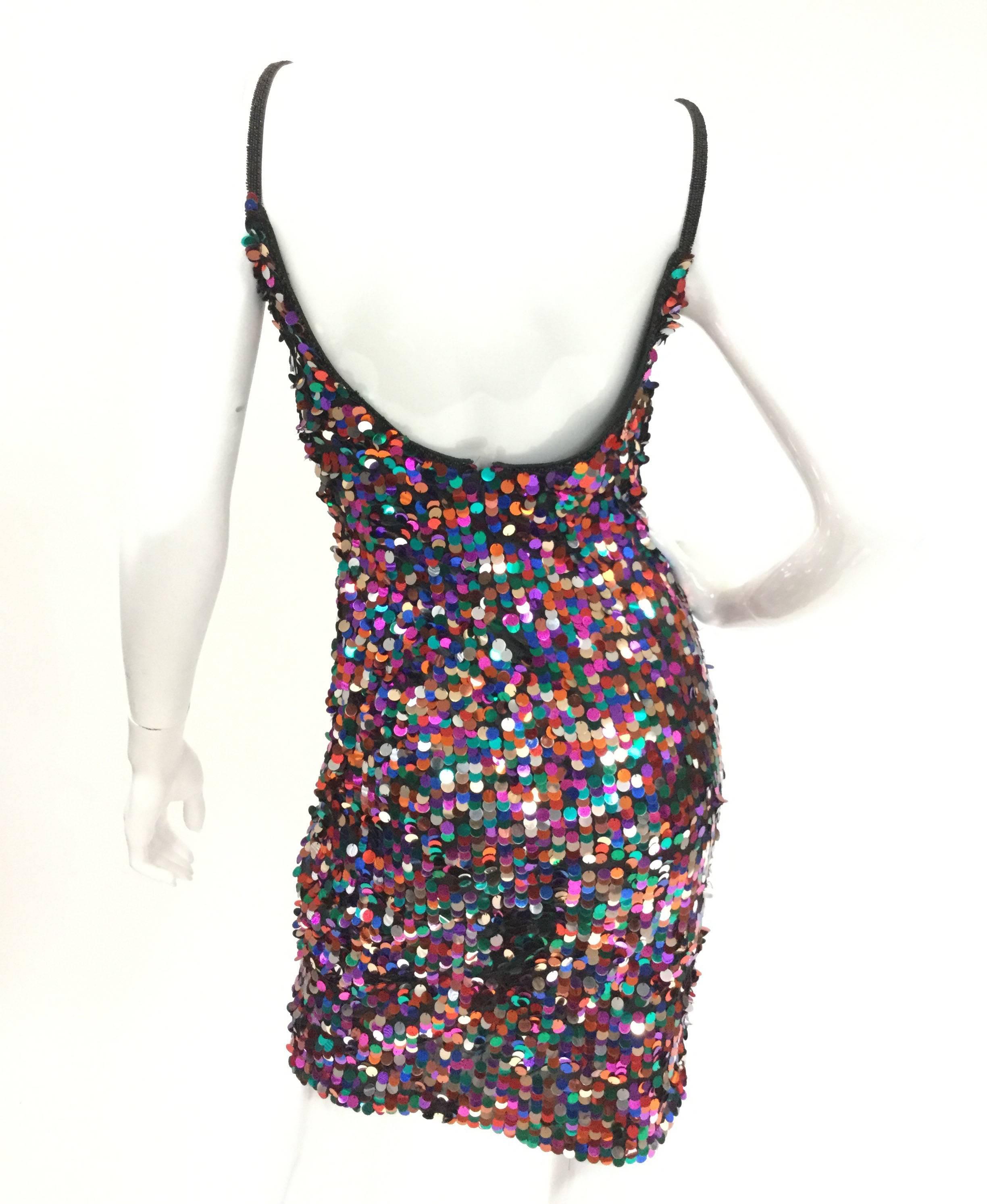 
Dance the night away in this gorgeous mini dress by Fred Hayman! The dress is heavily sequined in large multicolored paillette sequins. The sequins are attached at the top, allowing them to sway and flicker as you dance! This luminous dress has a