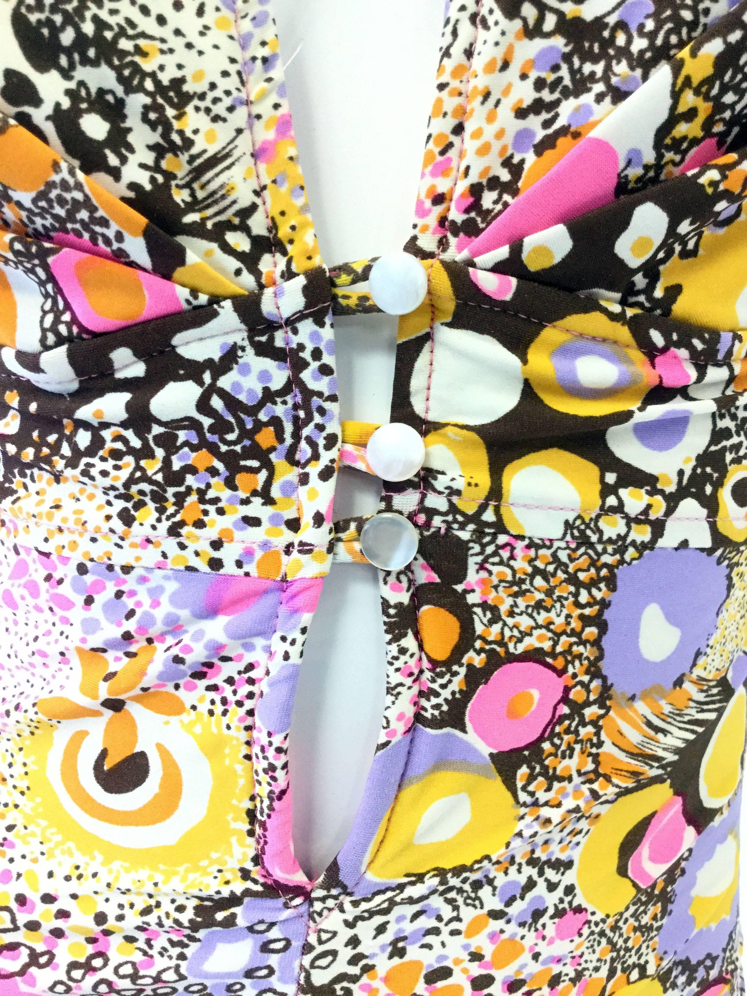 
This fantastic one-piece swimsuit by Jantzen features an eye-popping optical art print consisting of colorful abstract floral and animal print shapes that recall the psychedelic liquid light shows of the 1970s. This yellow, purple, pink, violet,