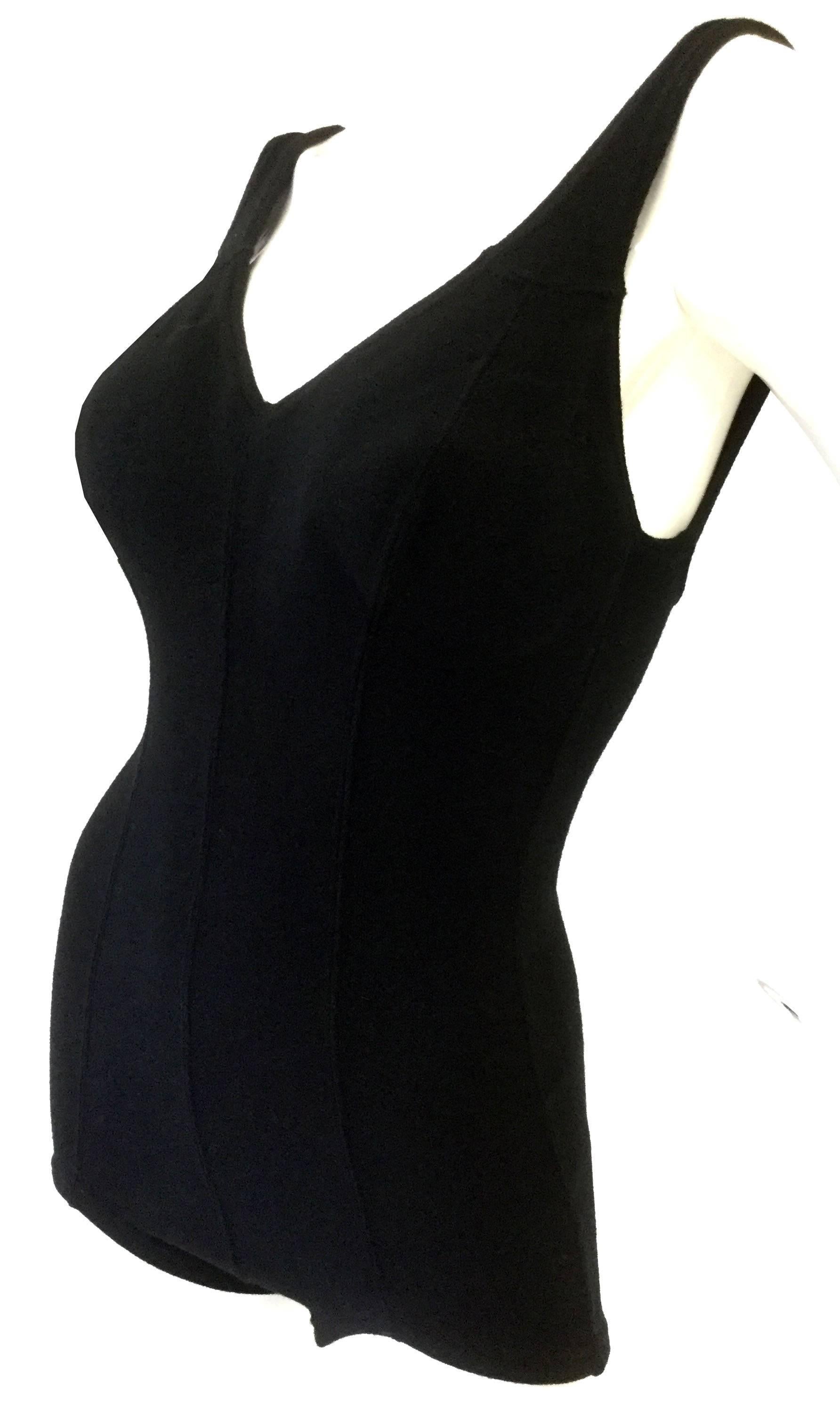 This adorable black swimsuit romper by DeWeese makes every shape look great!  it features a striking three line seam design at the center front, created by the garment's paneled construction. The piece has a boy-short bottom, a deep v-neck collar,