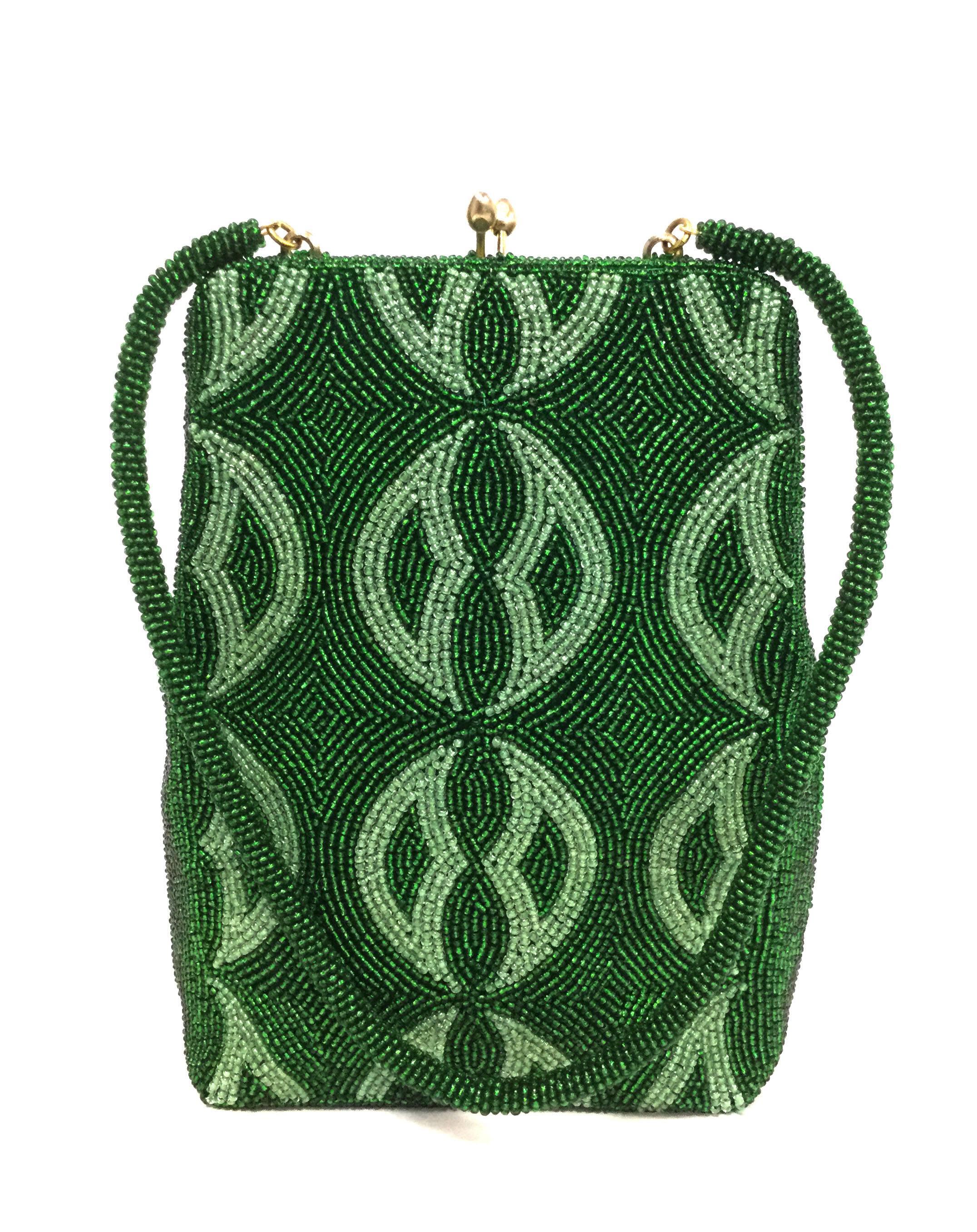 This gorgeous, shimmering mid century evening purse fully beaded - right down to the handle! The purse features a lattice pattern with a kelly green background and a pistachio green accent beading on the front. The rest of the purse is a solid