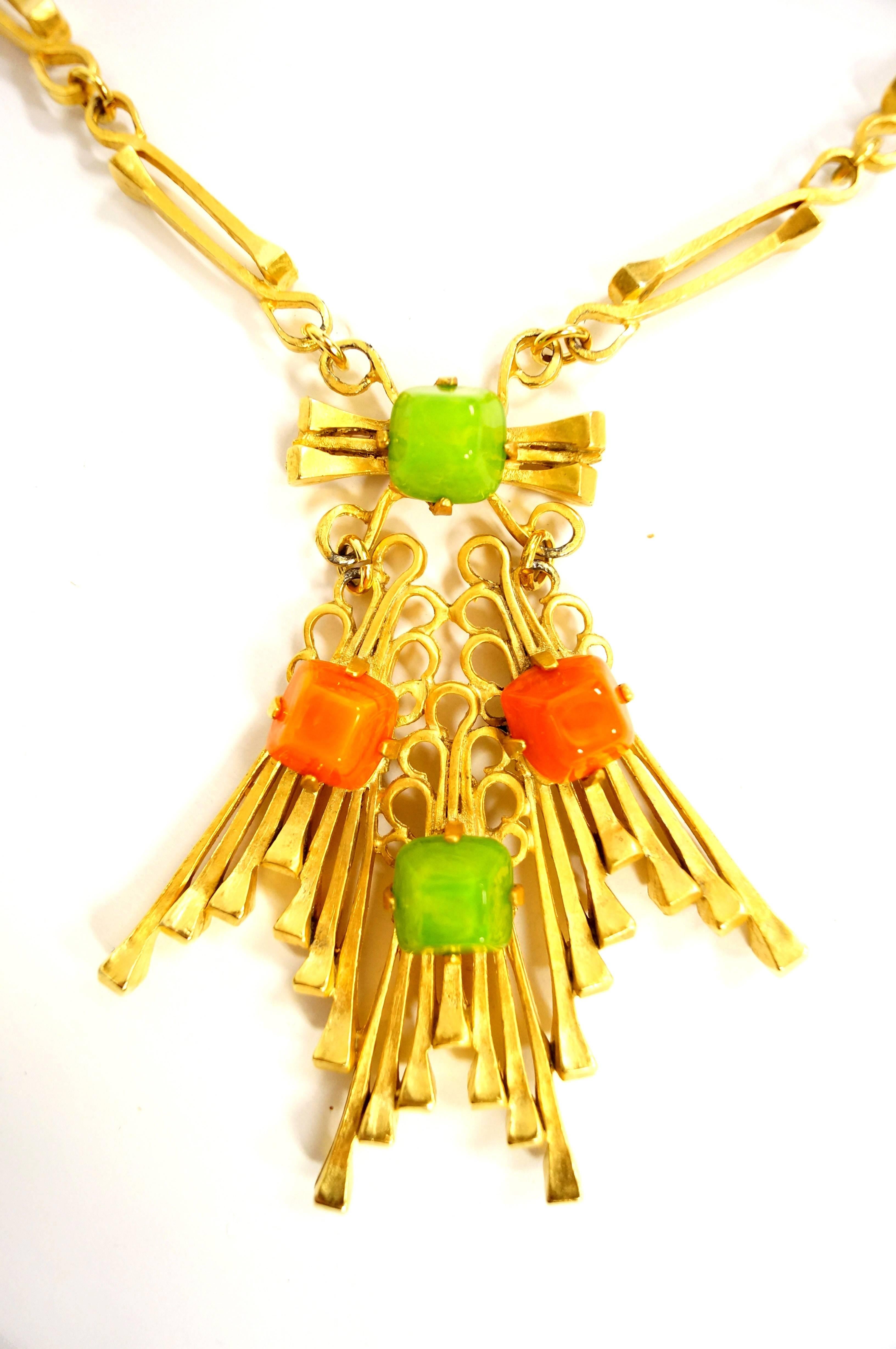 This Castlecliff jewelry set is stunning! The necklace is composed of gold tone horseshoe nails arranged in a sunburst slice, emanating from a lime green sugarloaf cabochon. The sunburst dangles freely from the primary cabochon, and is adorned with