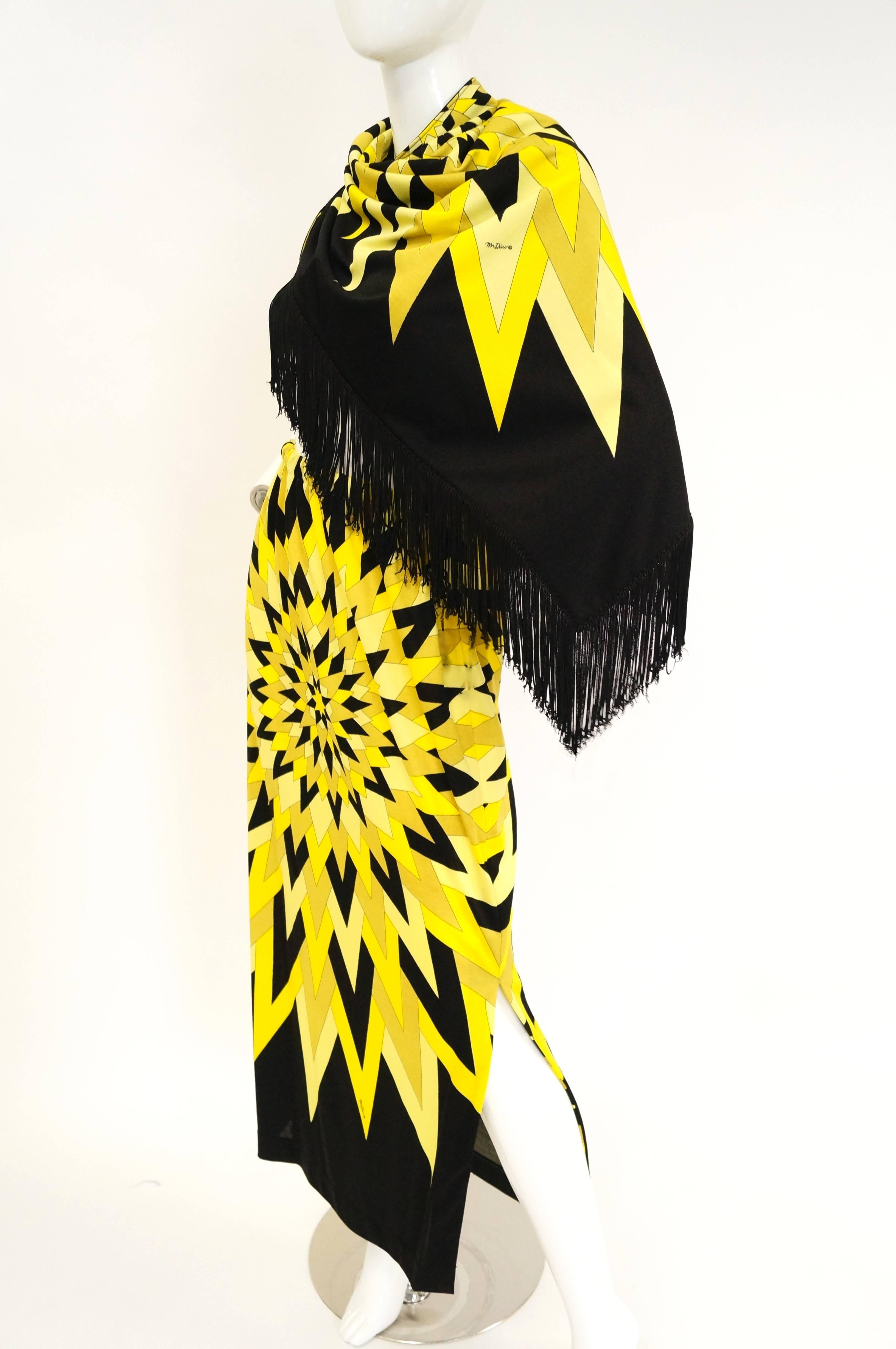 Outshine the sun in this sensational ensemble by Mr. Dino! The jersey knit ensemble includes a long sheath skirt with elastic waist and a dramatic long - fringe shawl. Both pieces are emblazoned with an amazing contrasting black and yellow geometric